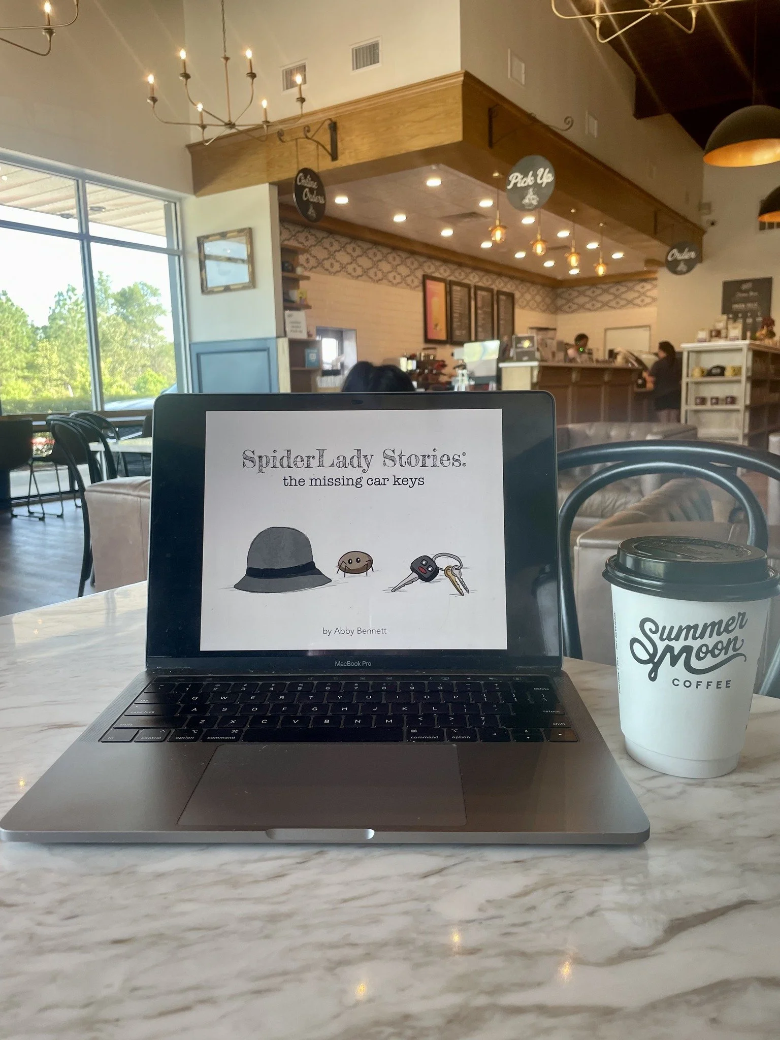 Where the magic happens! My Mac always sounds like an airplane taking off when I'm working, but that just means I'm working hard, right?!✈️🩵 Over the course of writing &amp; illustrating the first edition of The SpiderLady Stories, I visited many a 