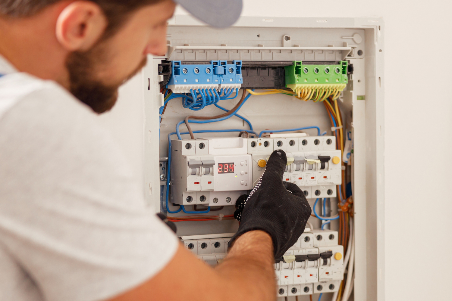 Man servicing an electrical box in a home
