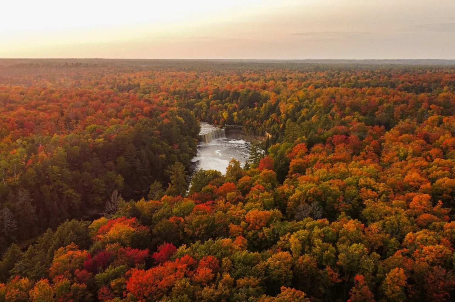 Aerial view of Taqhuamenon Falls colorful trees and waterfall