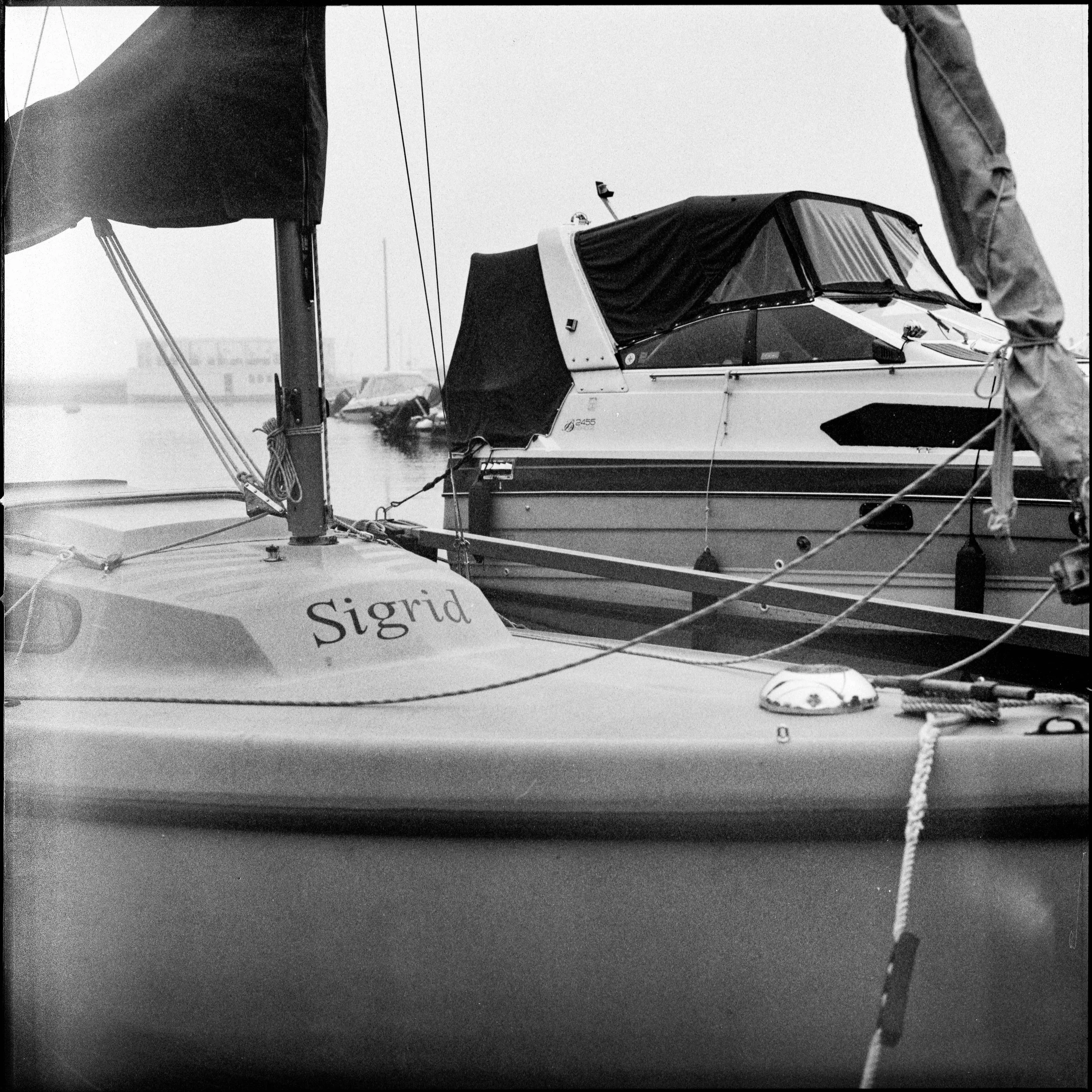 Två båtar, en med namnet Sigrid, ligger vid en kaj.