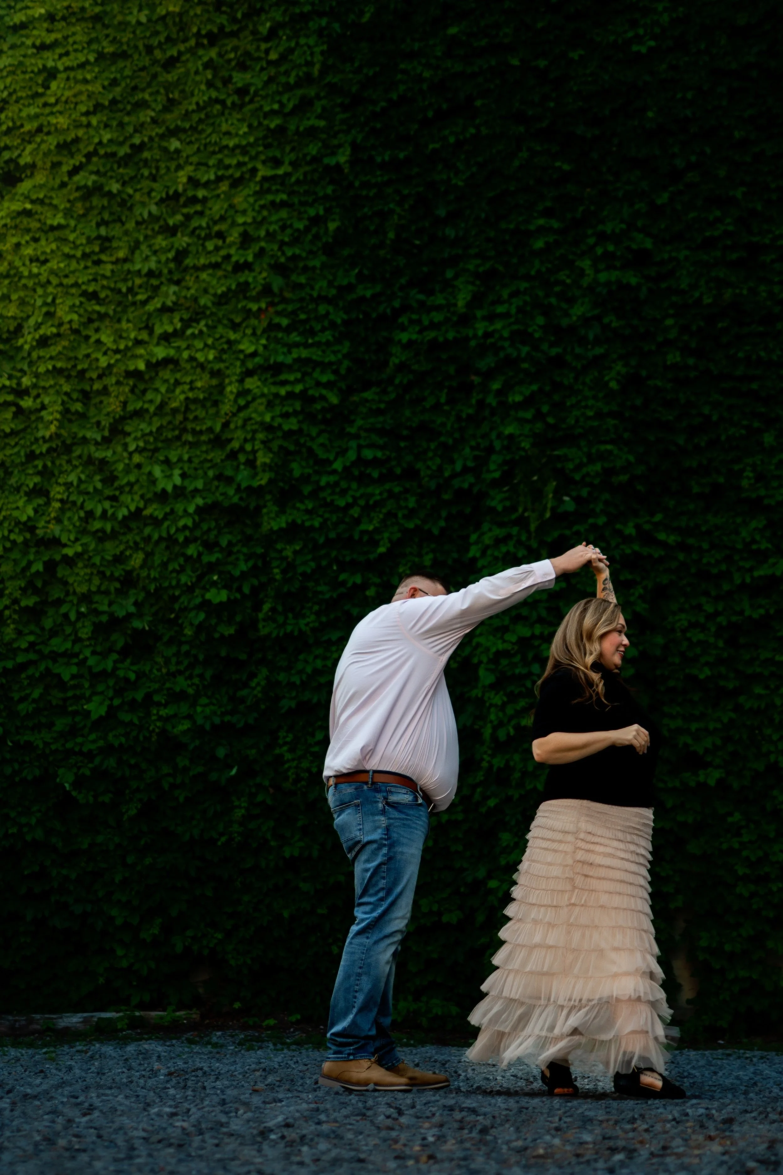 couple dancing with greenery behind them