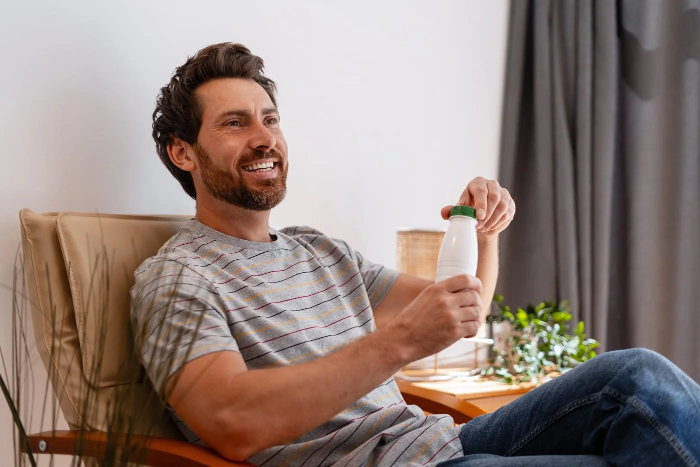 Man sitting down holding a drink