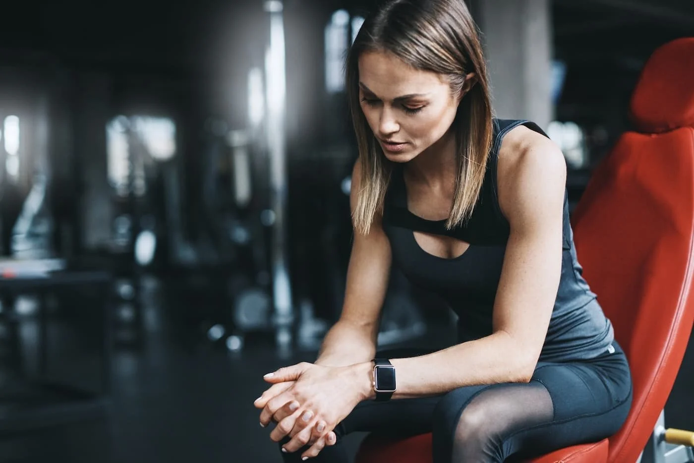 Woman sitting down at the gym