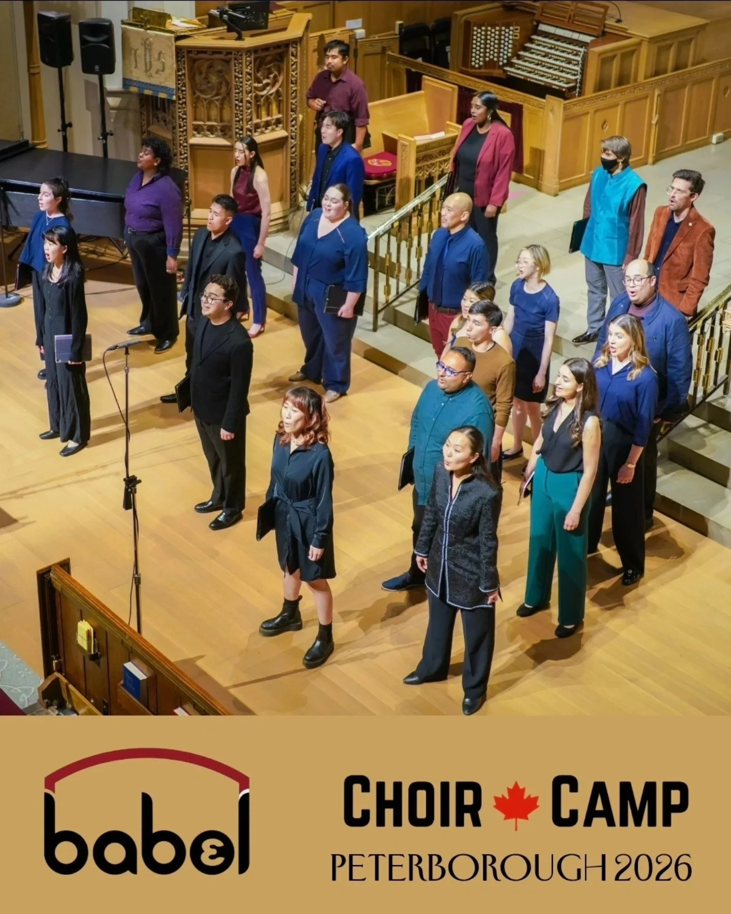 A group of choir singers standing on stage, facing forward during a performance, with a conductor or speaker microphone in front. The stage is in a church or concert hall with wooden decor. The bottom overlay has a logo and text that reads 'Babel Choir Camp Peterborough 2026' with a red maple leaf.