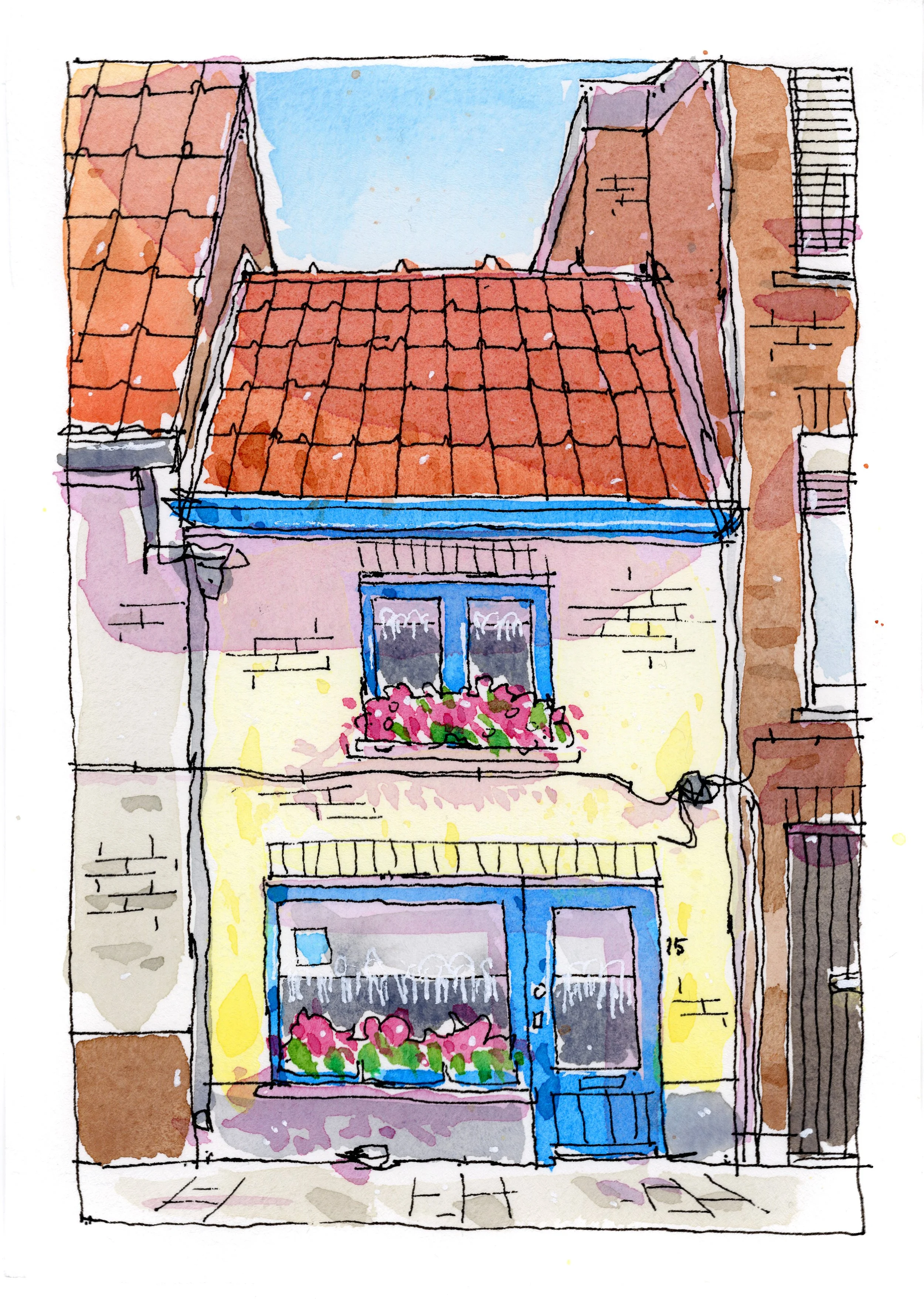 Watercolor sketch of a two-story building with a red-tiled roof, yellow walls, and blue window and door frames. The building features flower boxes with pink flowers on the second-floor window, and a large window with flowers on the ground floor. Surr