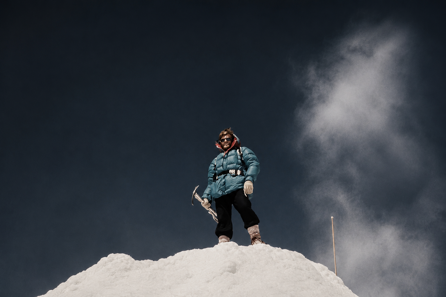 Kluane Mountaineering climber standing on a snowy ridge