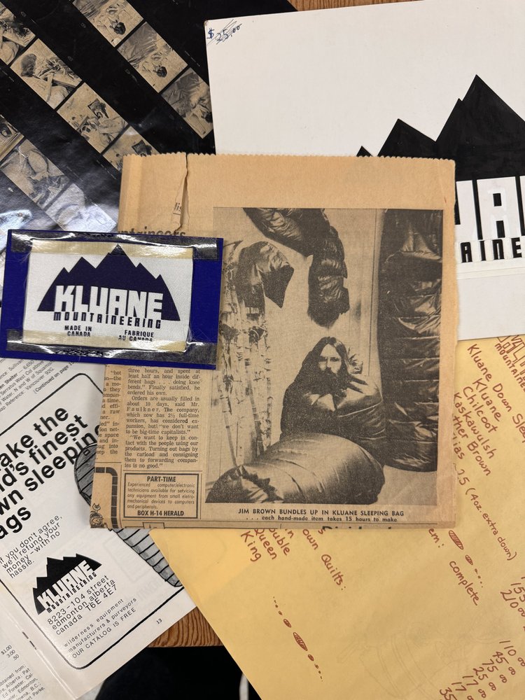 Newspaper clipping of Kluane co-founder Jim Brown with a Kluane sleeping bag