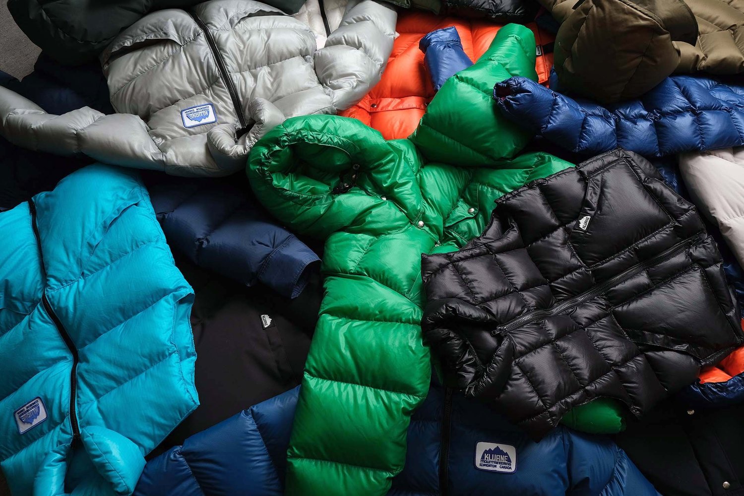 Pile of Kluane down jackets and vests