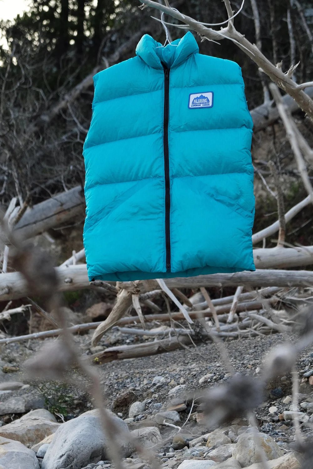 Blue Kluane Down Vest hanging outdoors