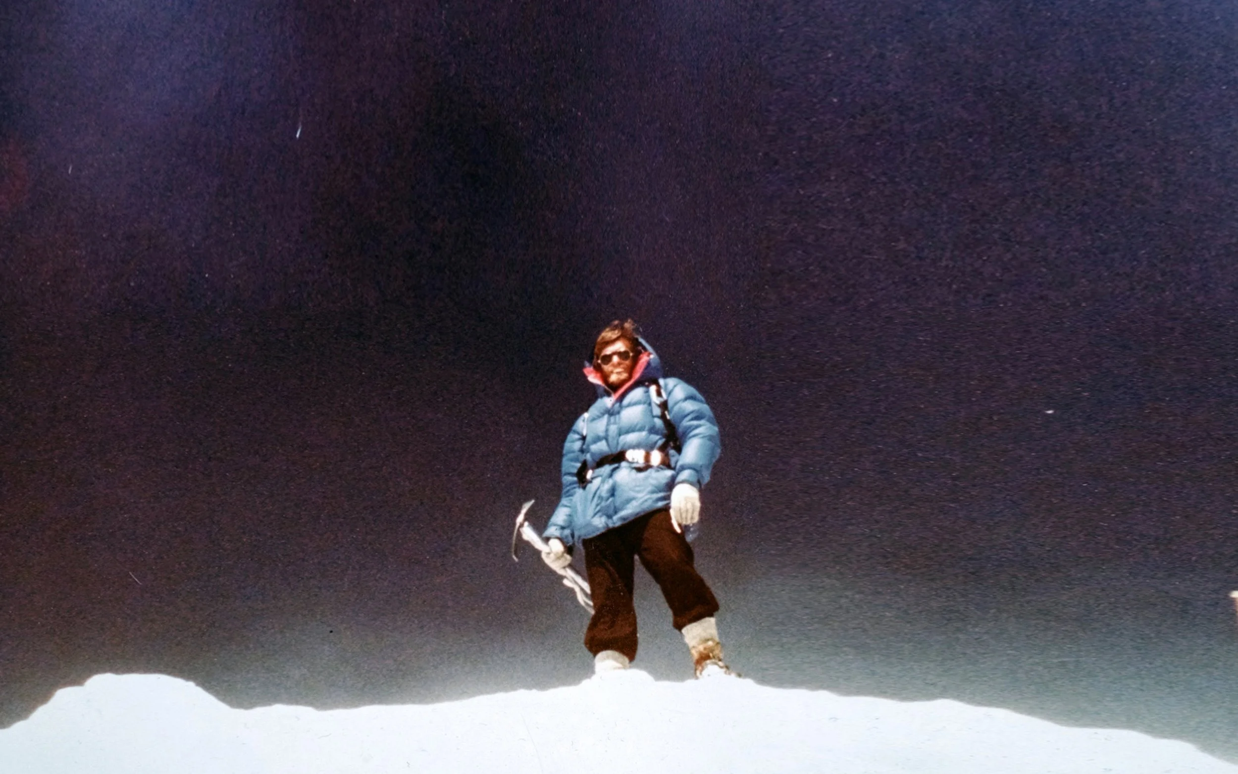Kluane Mountaineering climber standing on a snowy ridge