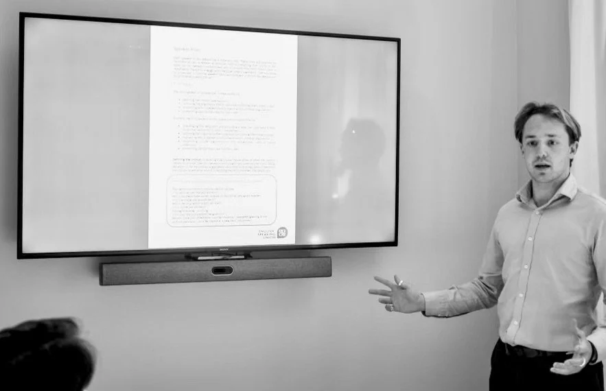 Tutor teaching English at whiteboard