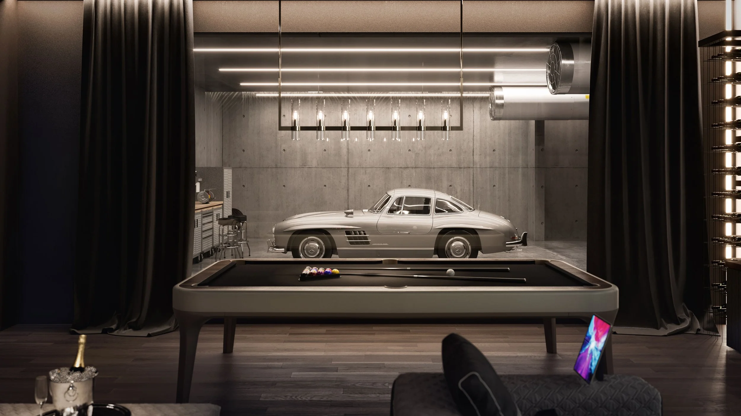 A luxury game room with a modern concrete wall and ceiling lights, featuring a silver vintage car stored behind a large glass window, a pool table in the foreground, and a tablet nearby.