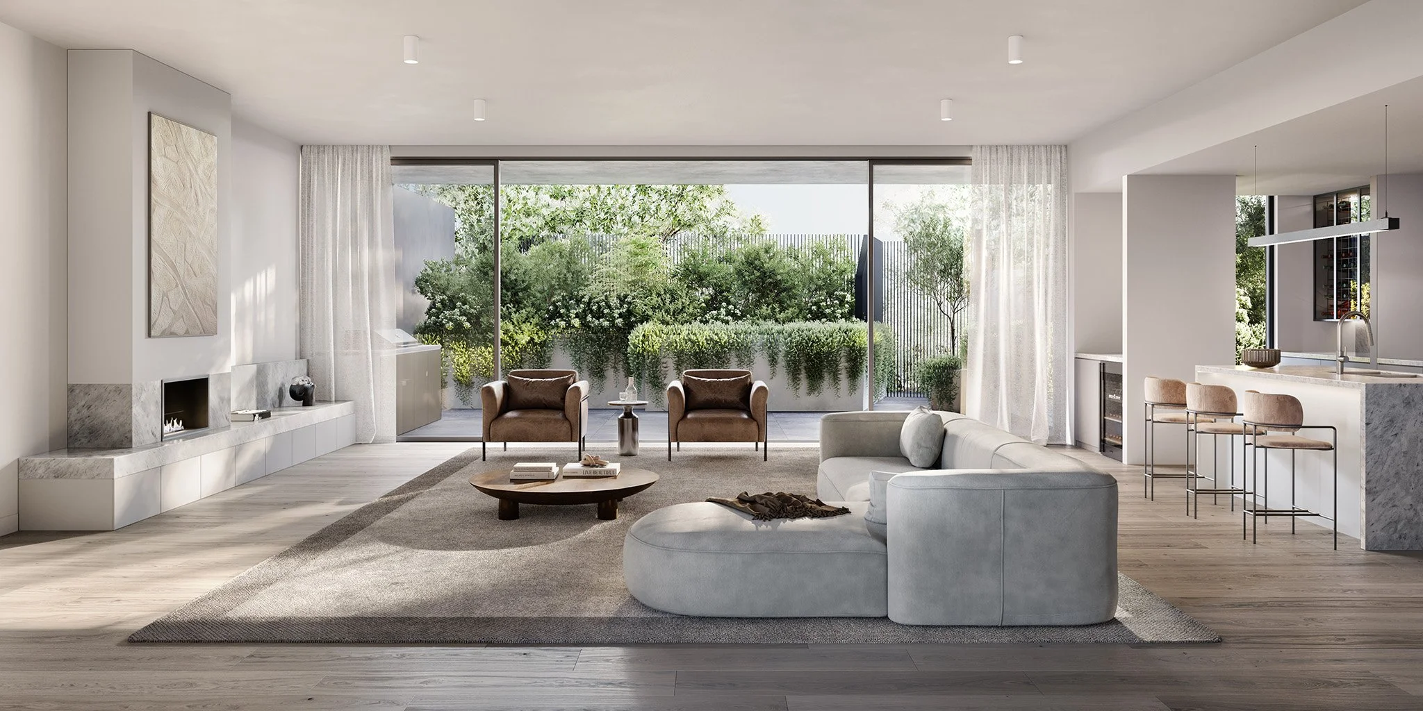 Modern living room with large glass sliding doors overlooking a lush garden, white walls, and light wooden flooring. Features include a white curved sofa, two brown armchairs, a round wooden coffee table, and a fireplace with a marble surround. There
