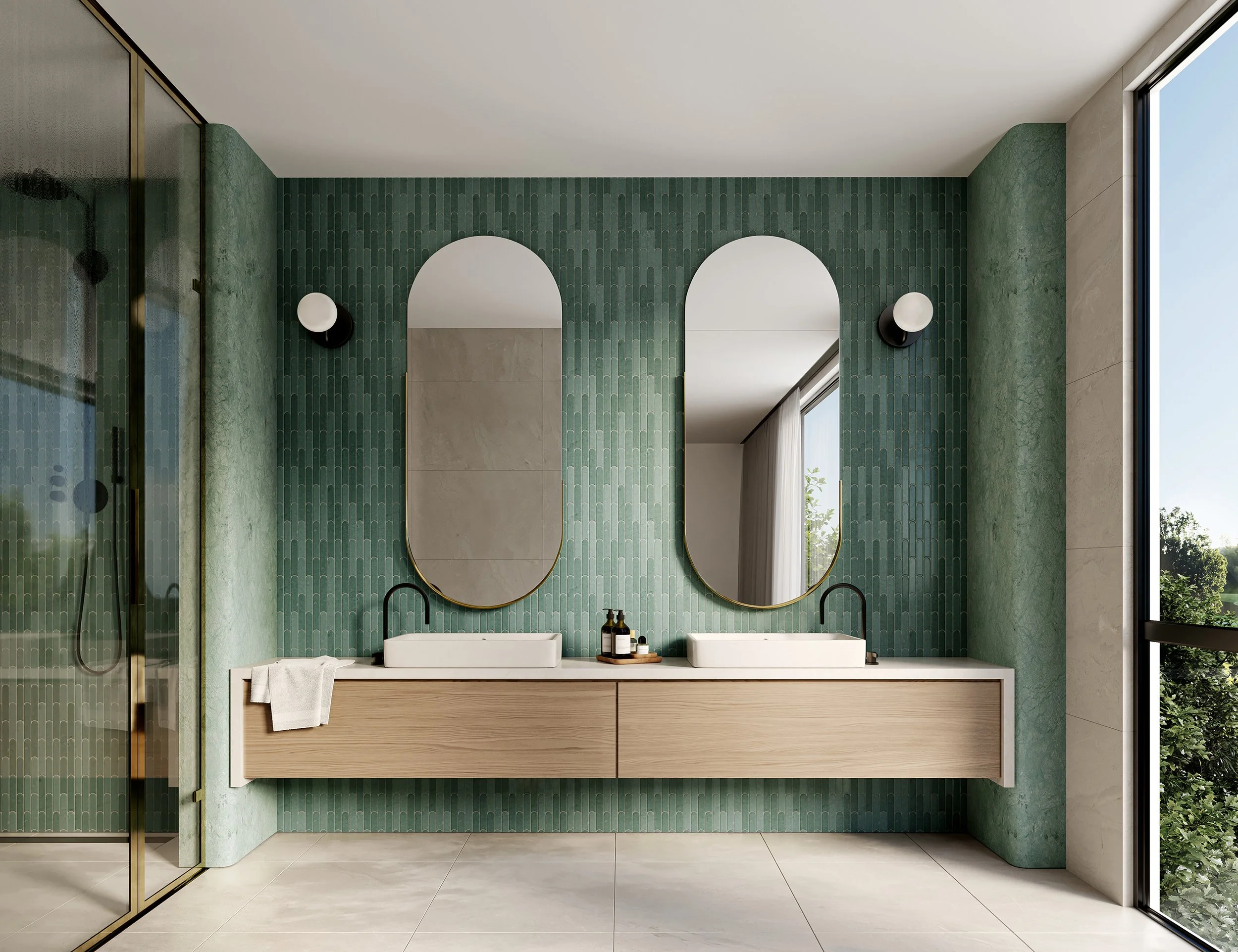 Modern bathroom with twin rectangular sinks, oval mirrors, green tiled wall, black wall sconces, large window with a view of trees.