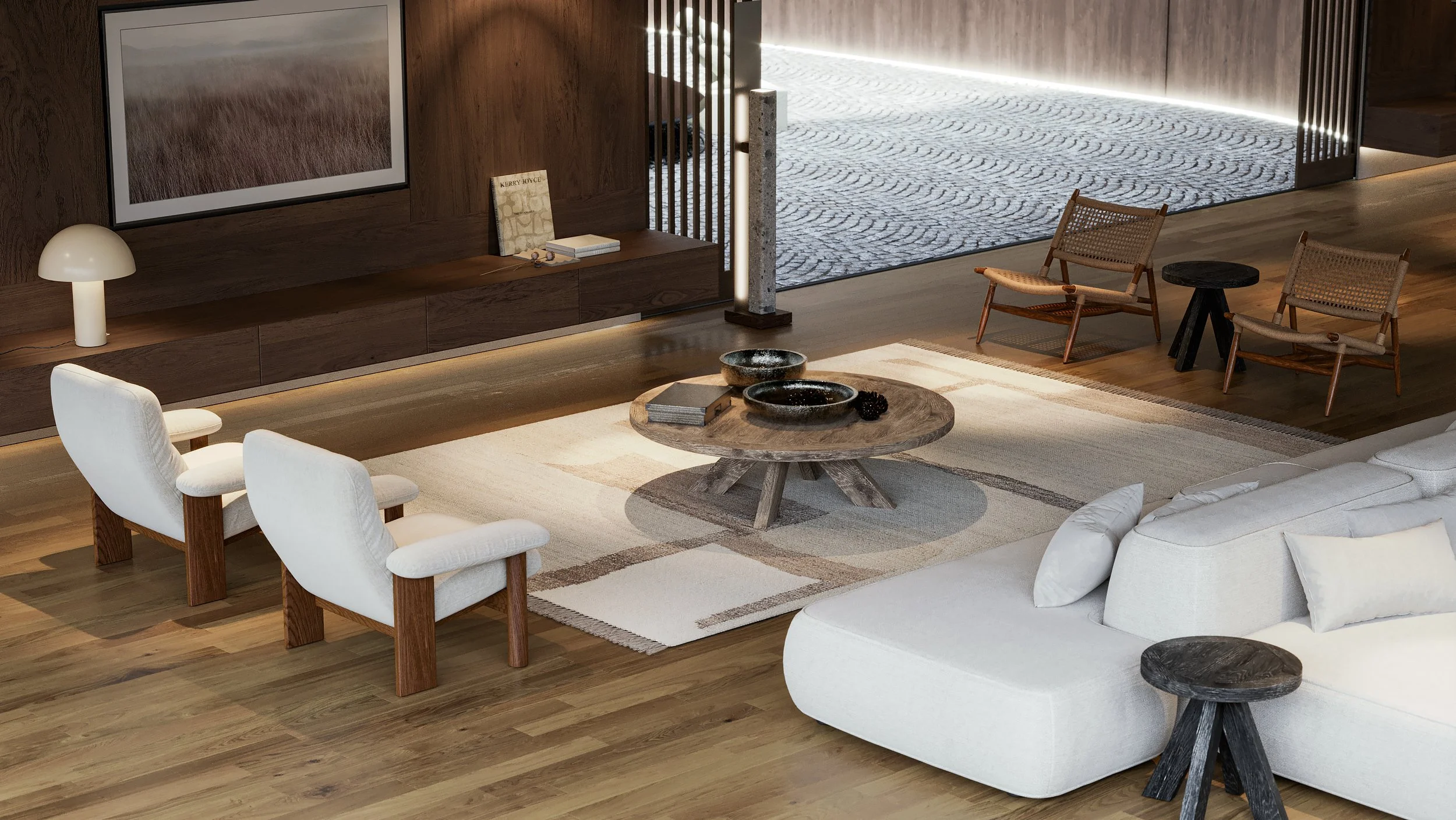 Modern living room with white sofa, wooden chairs, round coffee table with bowls and books, TV on wooden wall, and decorative lighting, with an open patio outside.