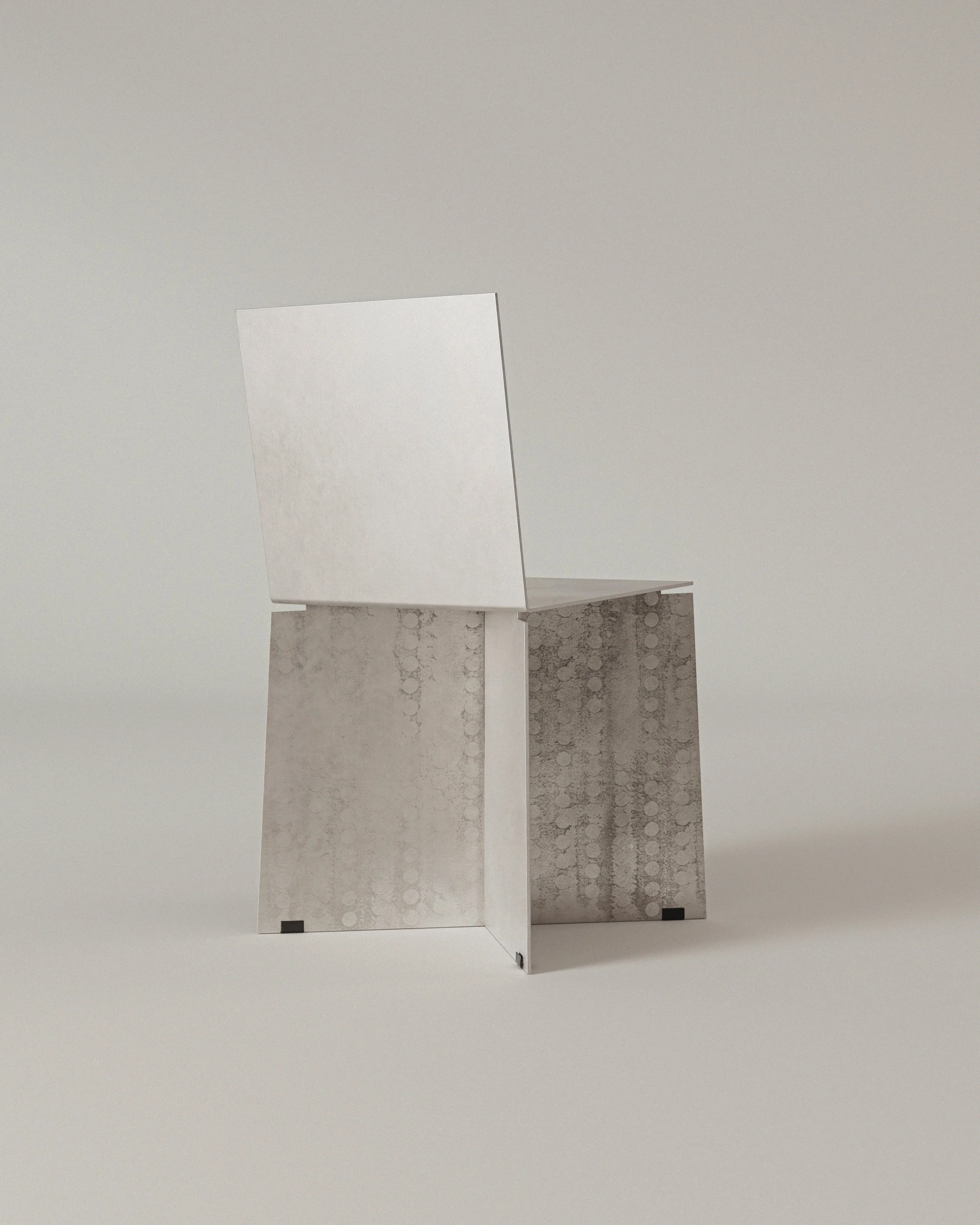 The image shows a metallic chair with a geometric design, featuring a square seat and backrest. The chair has a modern, minimalist aesthetic with a metallic finish and a pattern on the backrest.