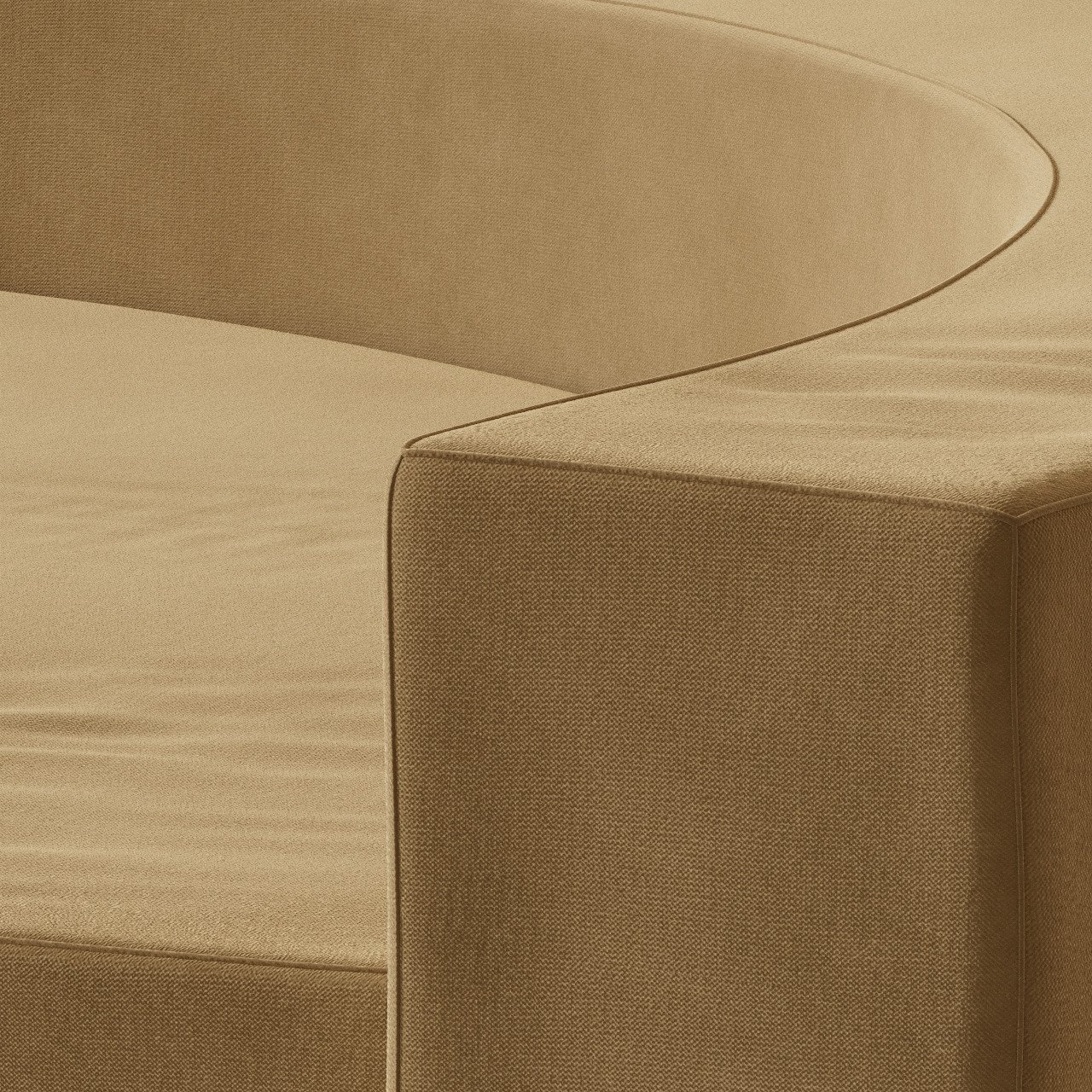 Close-up of beige upholstered furniture with curved armrest and visible seam stitching.