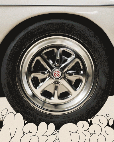 Close-up of a chrome wheel on a beige vehicle with cartoon-style doodles at the bottom.