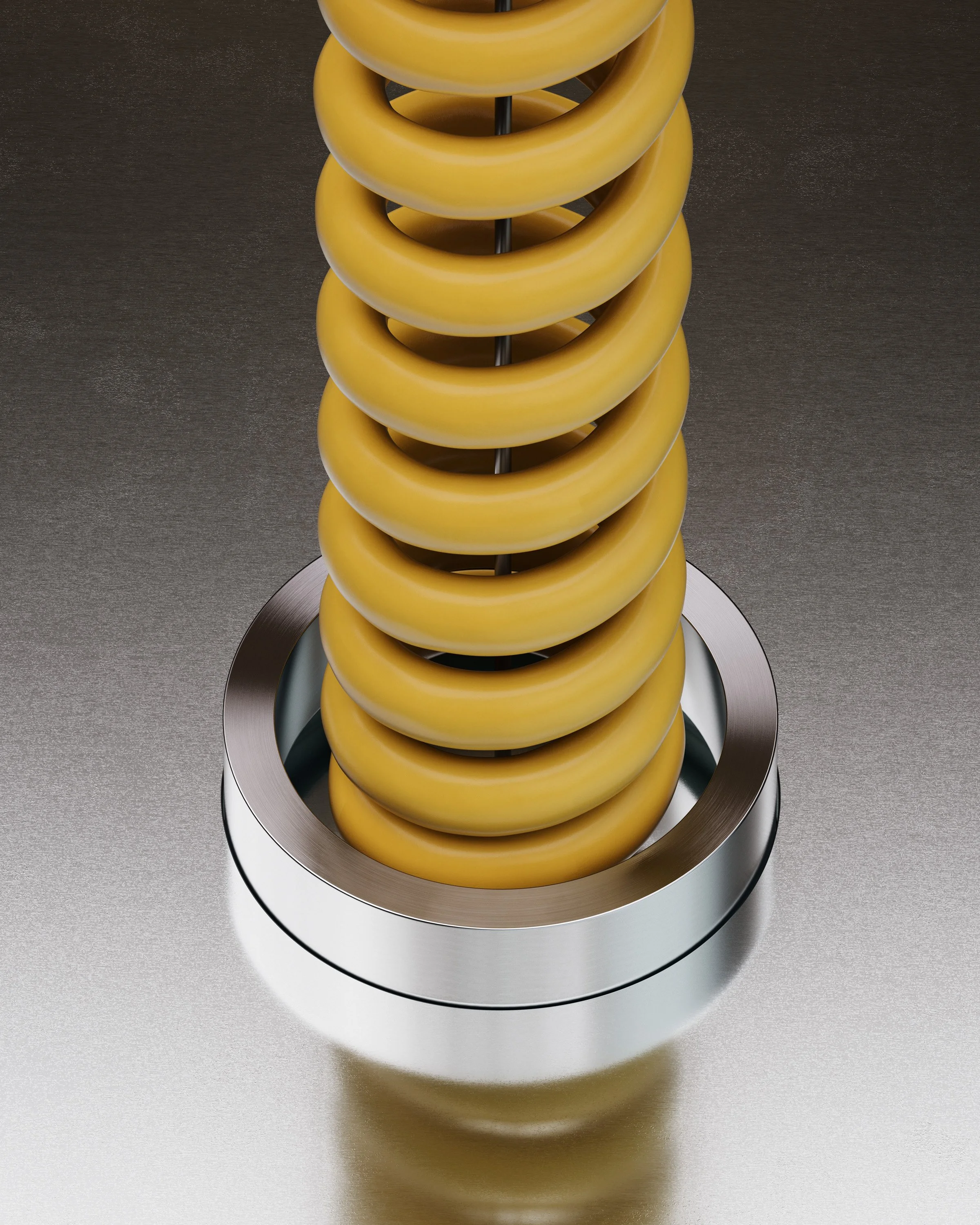Close-up of a yellow coil spring mounted on a metallic base.