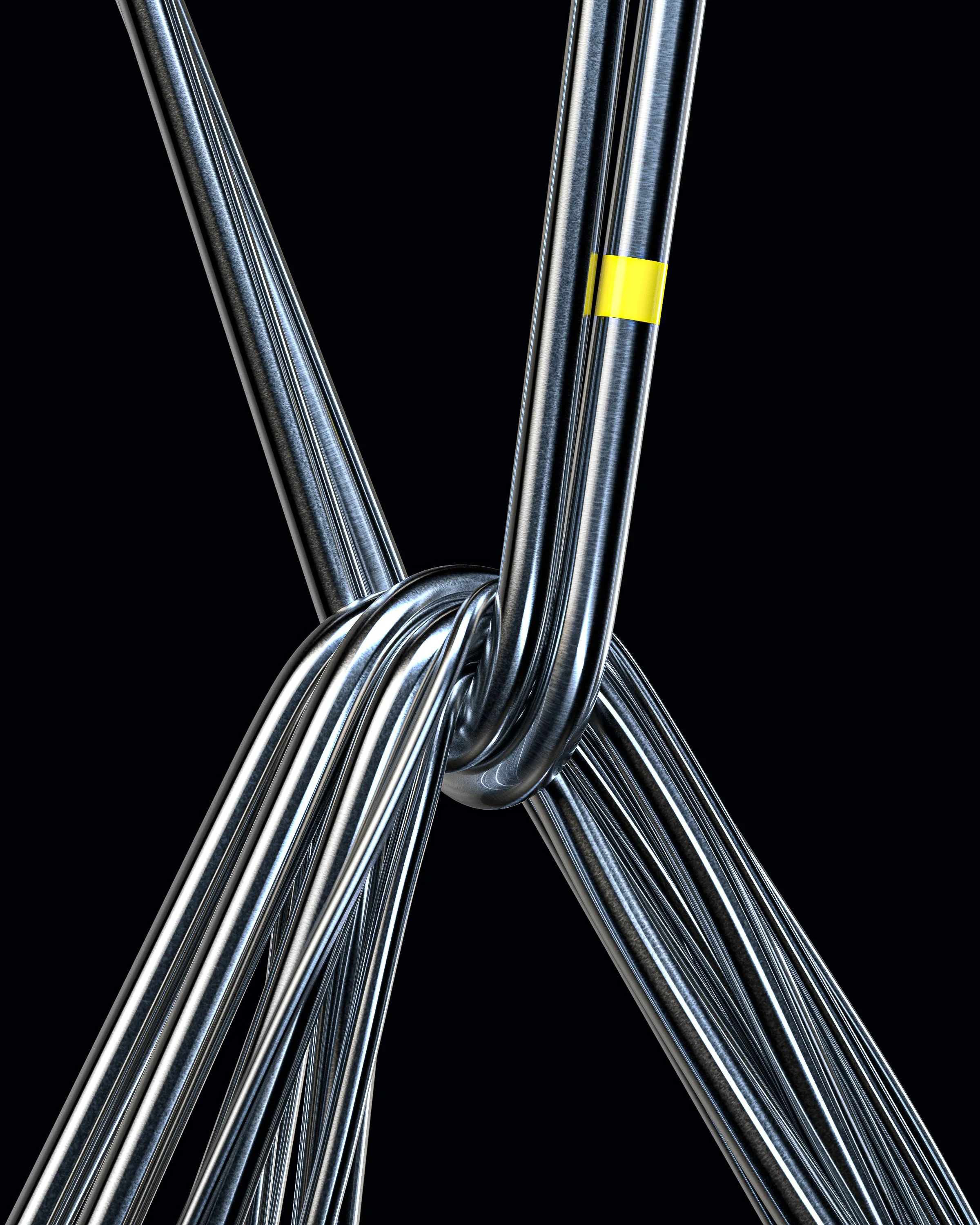 Close-up of multiple shiny metal bicycle lock cables looped together in a knot with a black background.