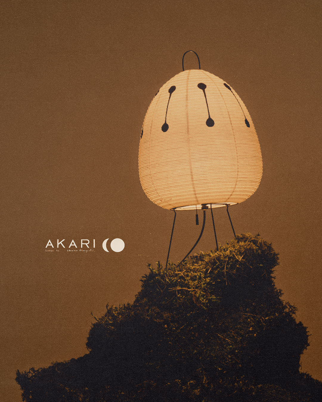 An egg-shaped Akari lantern with subtle black dot details rests on a mossy surface, set against a warm, reddish-brown backdrop, emphasizing texture, softness, and ambient light.