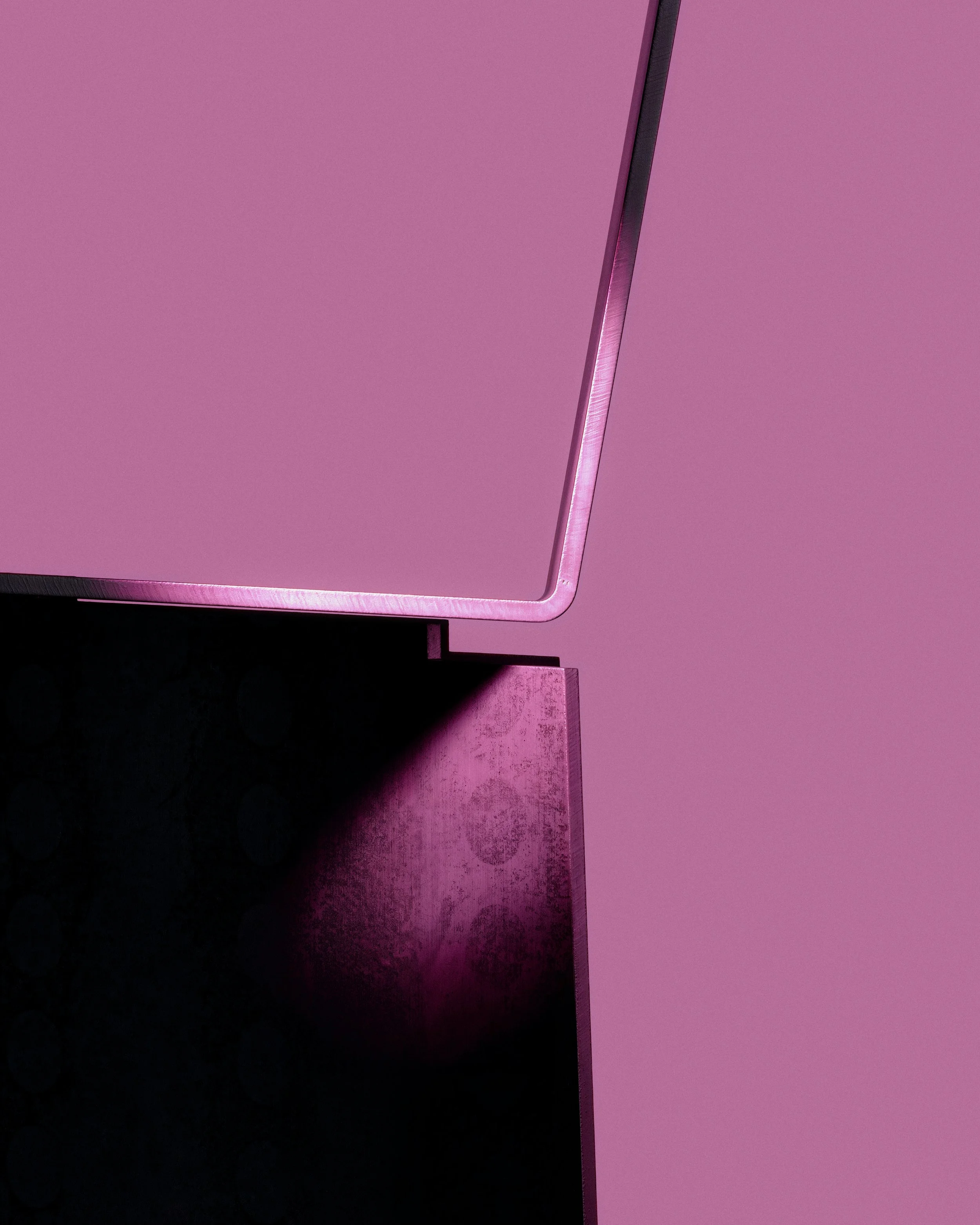 Abstract close-up of a sculptural chair, highlighting geometric edges, material surfaces, and soft magenta lighting in a minimal design study. LOES BETA GMBH