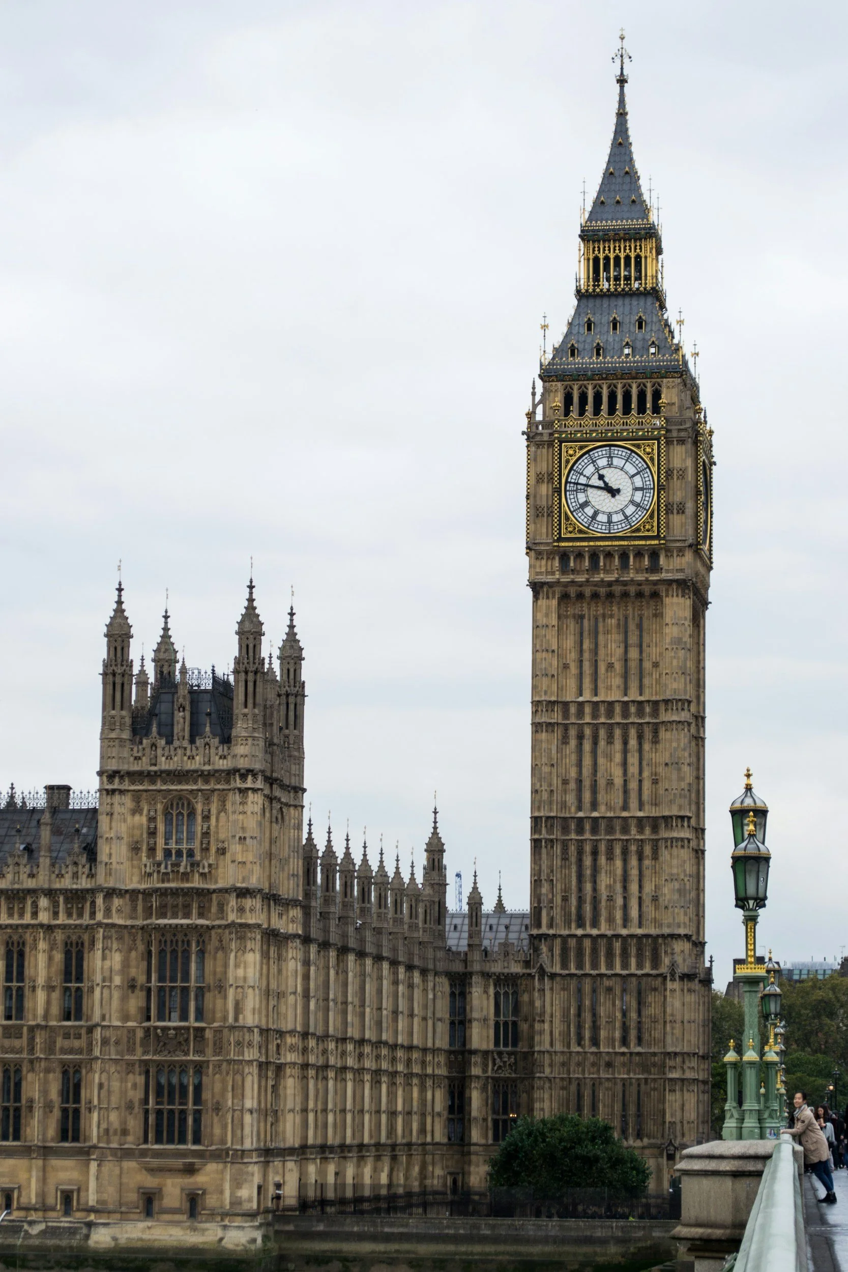 Big Ben clock tower near the Houses of Parliament in London, England, on a cloudy day.