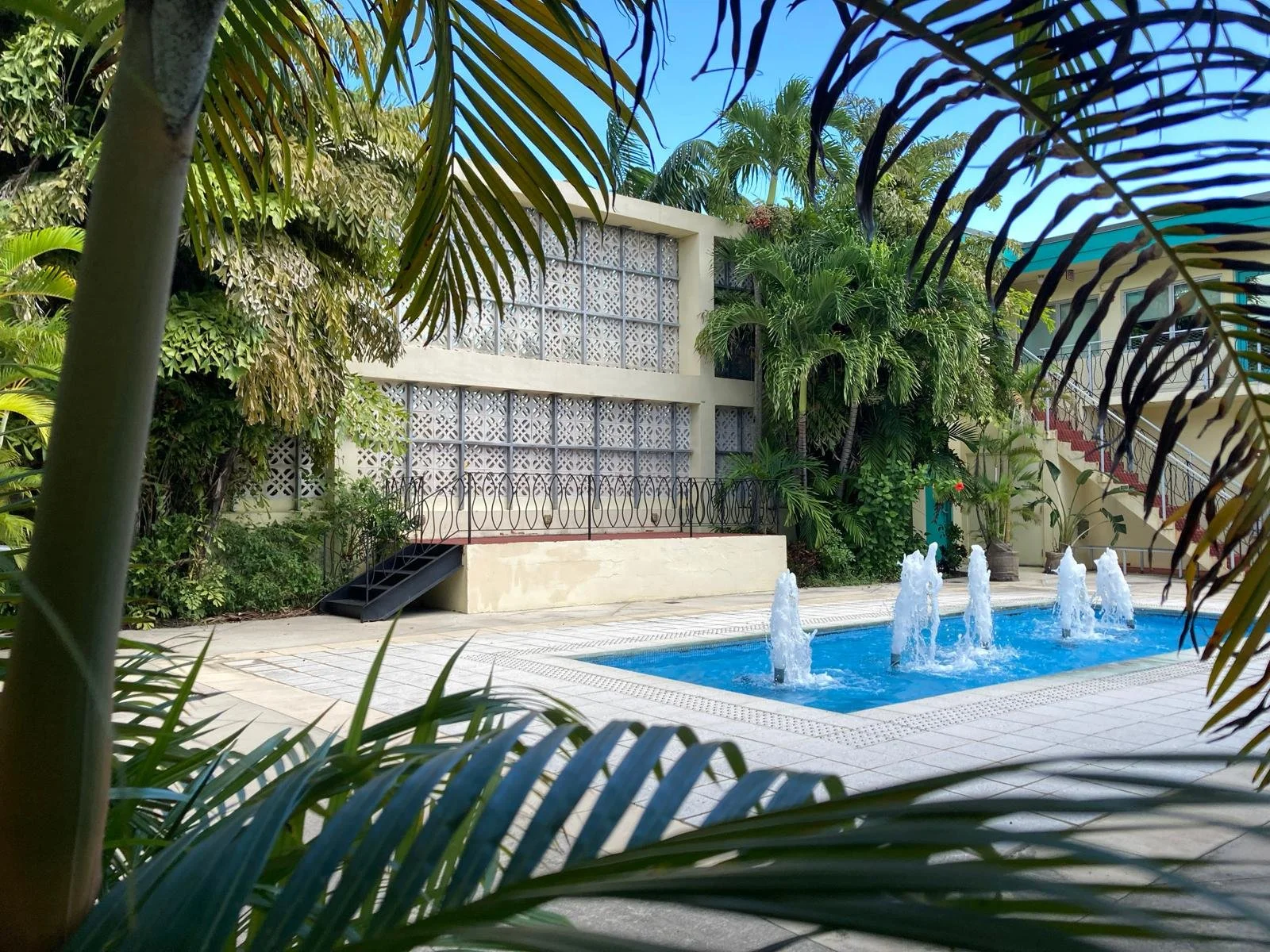 exterior-courtyard-through-palms-fountain-breeze-block-cinematic.jpg