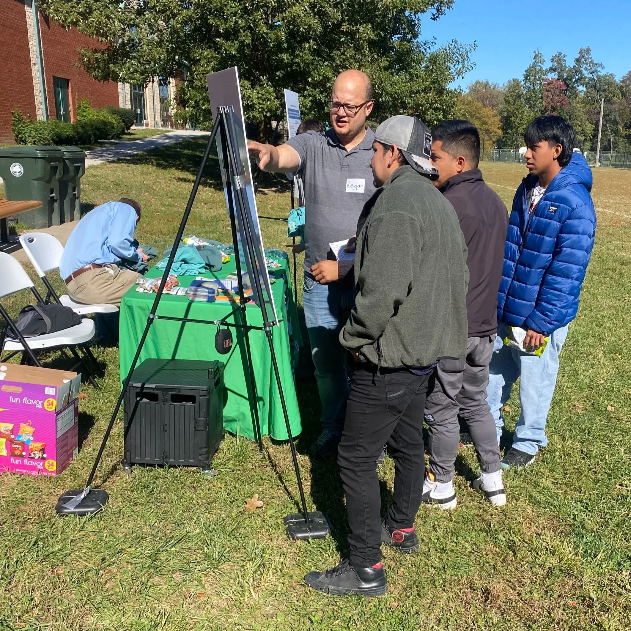 Community members learning about the Athletic Fields Usage study at a pop up event.