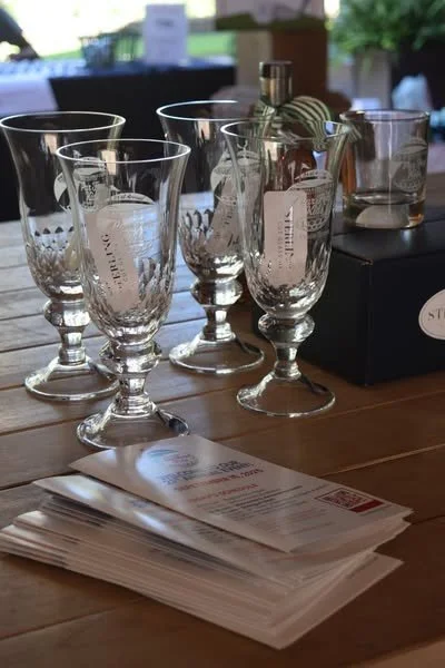 Several empty Stella glassware and a bottle on a table, with a stack of papers and a box nearby.