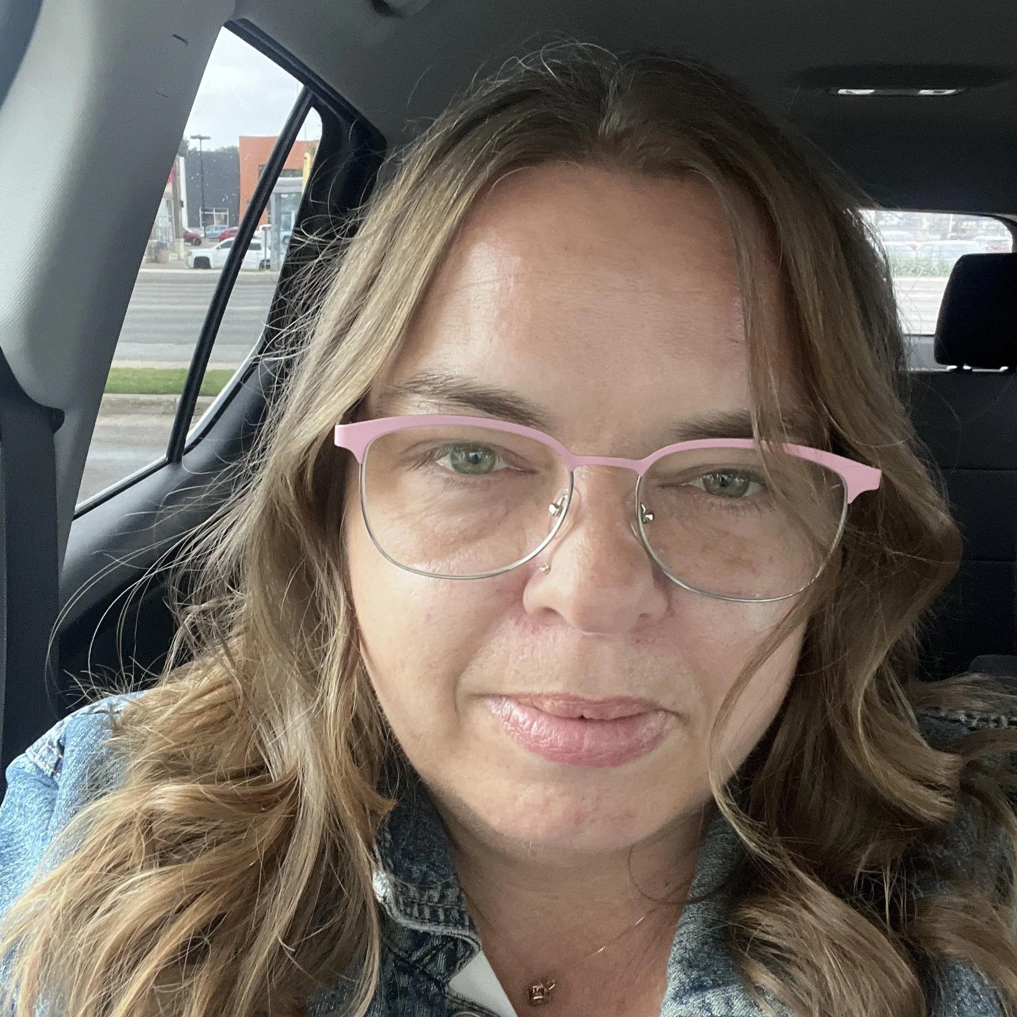 A woman grooming a dog on a grooming table in a pet grooming salon.