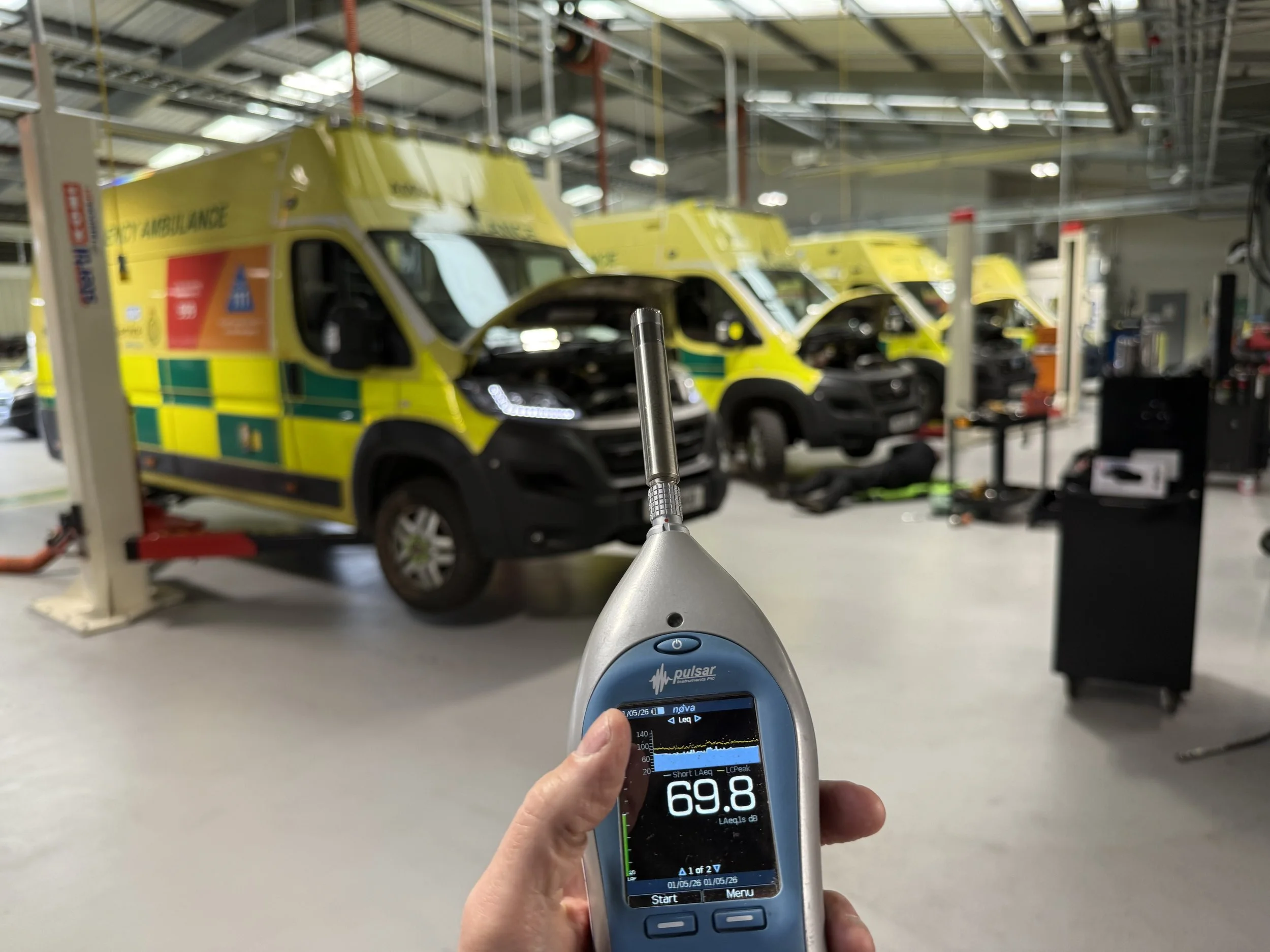 Noise meter with ambulances in background, used on a noise assessment