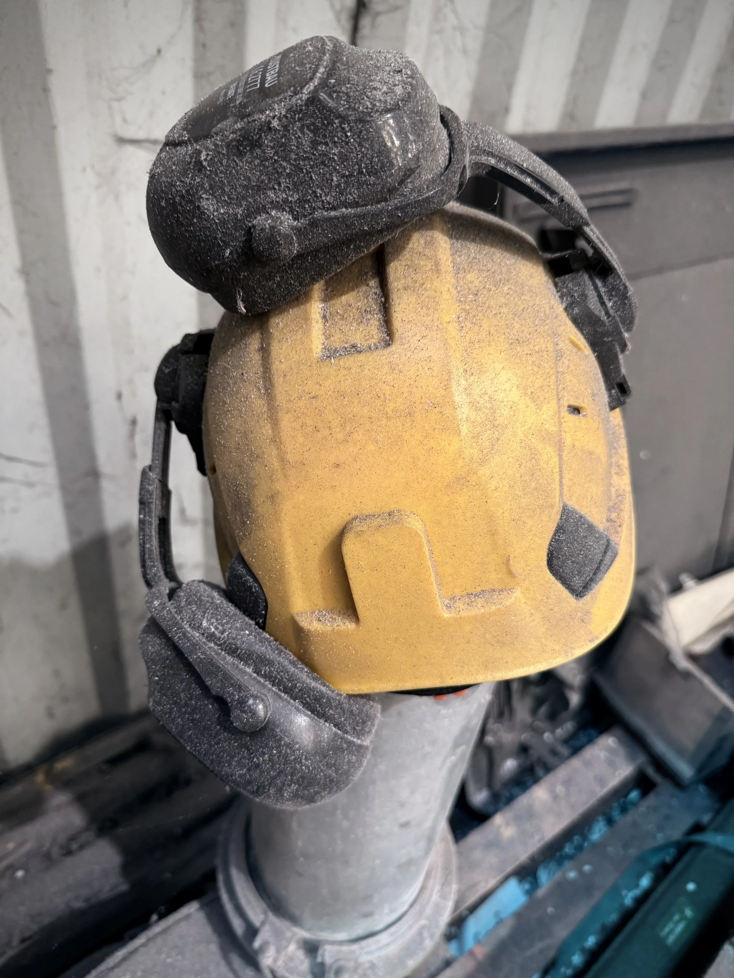 Ear muffs which have been covered in dust - clearly unused