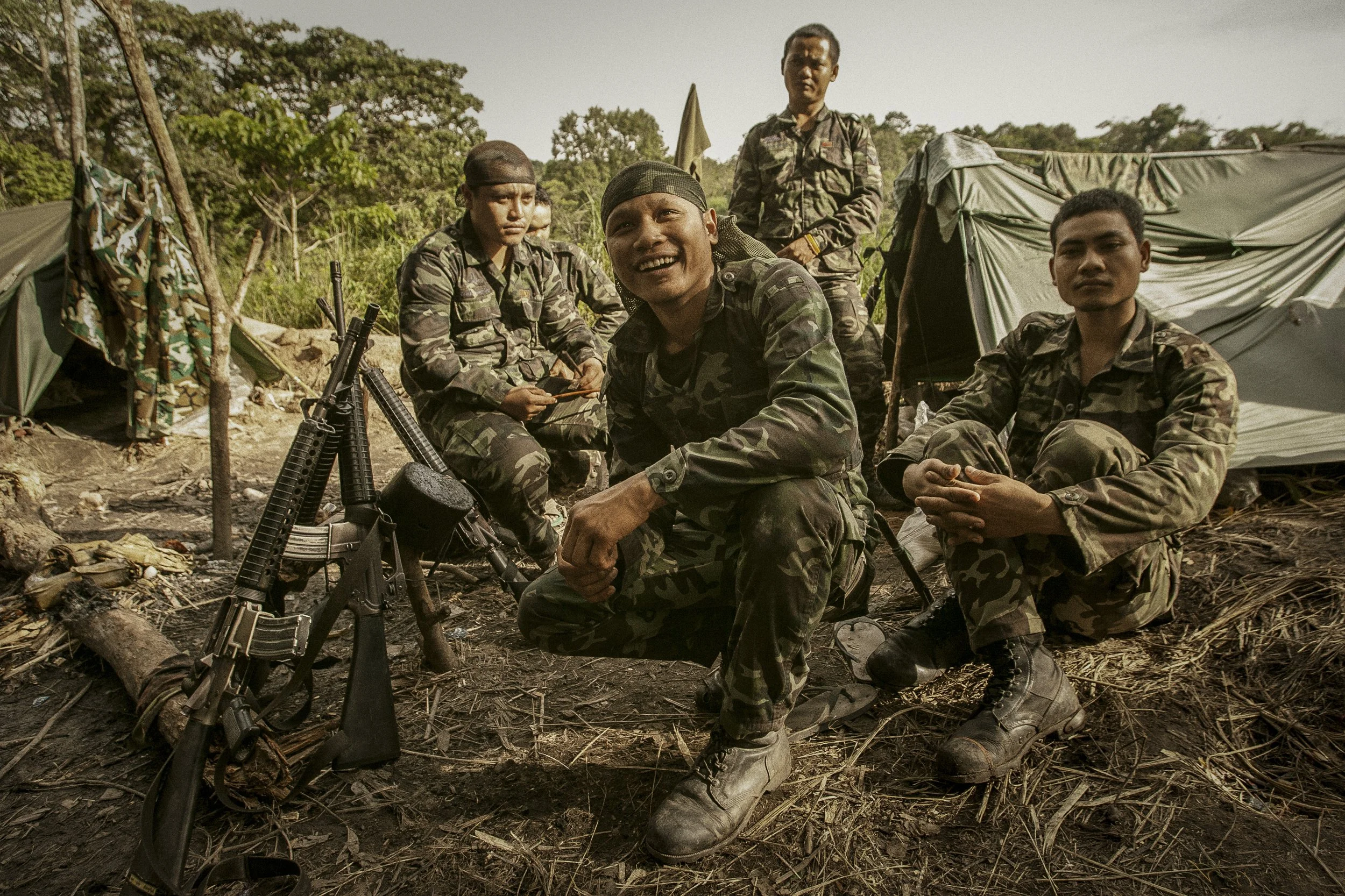 Thai soldiers with their M-16s enjoy some downtime outside of their outpost along the disputed border area.