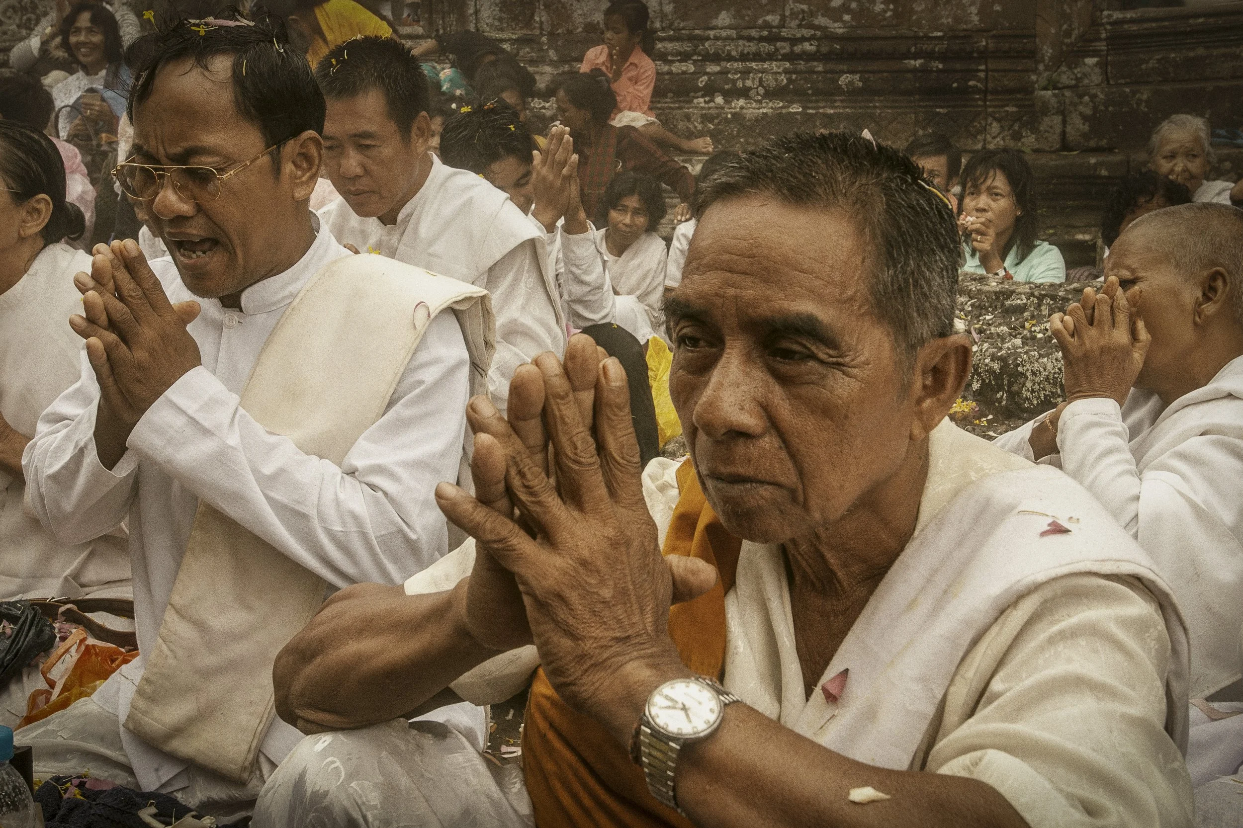 Cambodian religious supporters of all ages join in Buddhist prayer and melodic chanting.