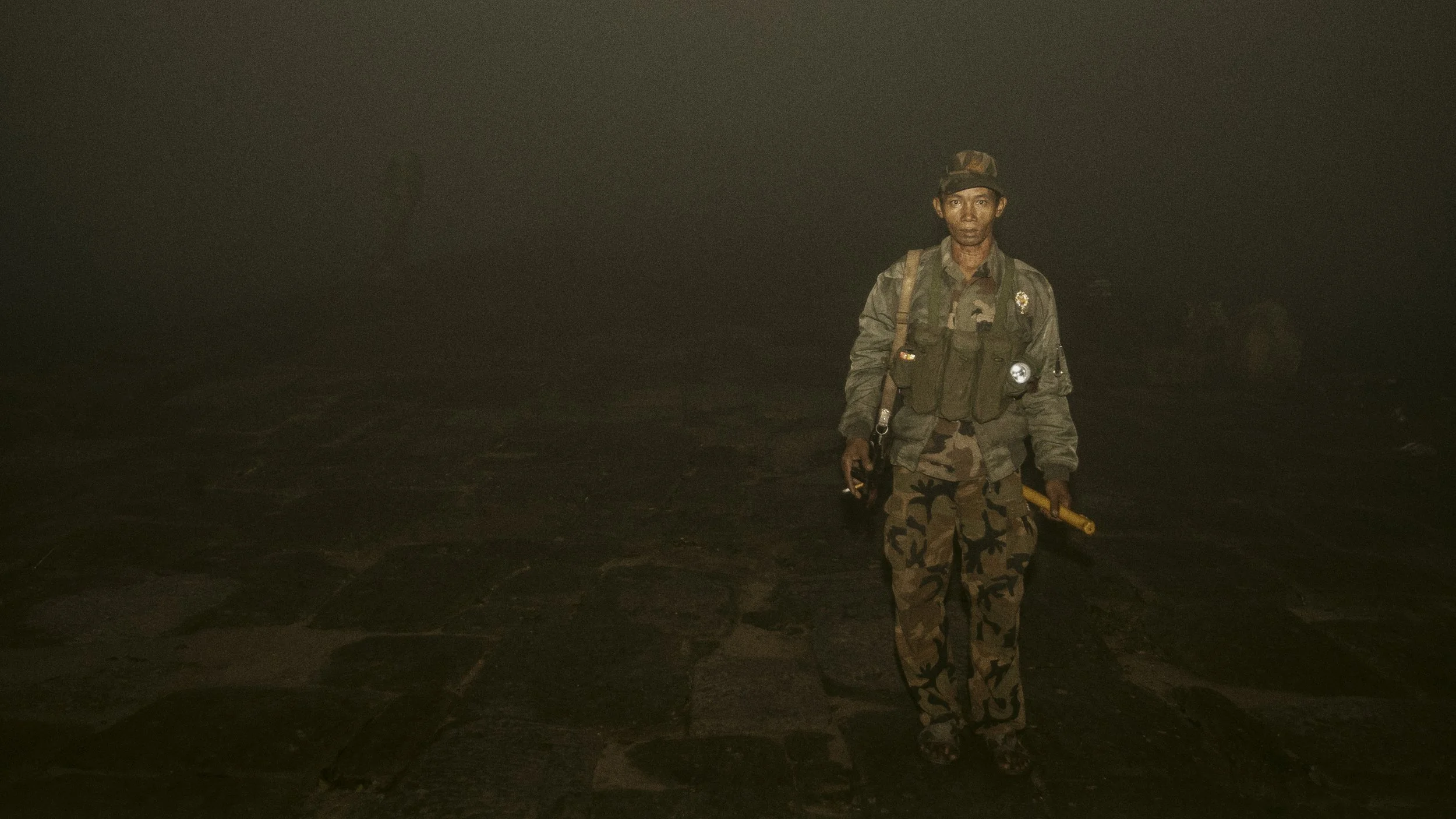 A dense fog envelops the area as this RCAF soldier makes his way along the ancient stone pathway leading to the temple. 