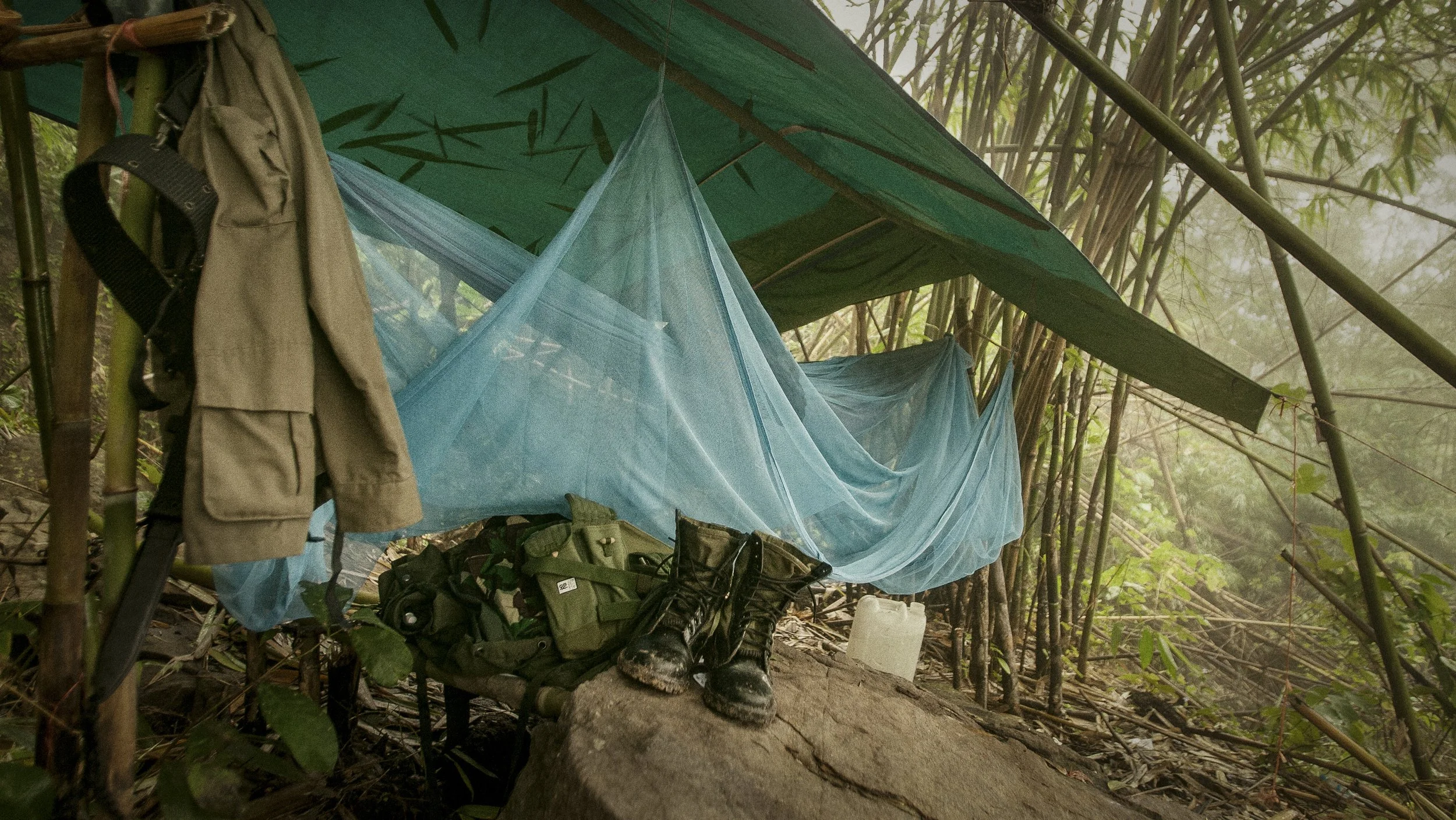 This is one of the more comfortable camps and outposts I had encountered along this escarpment. It consisted of nothing more than a tarp and mosquito net. The combat boots have been strategically placed.