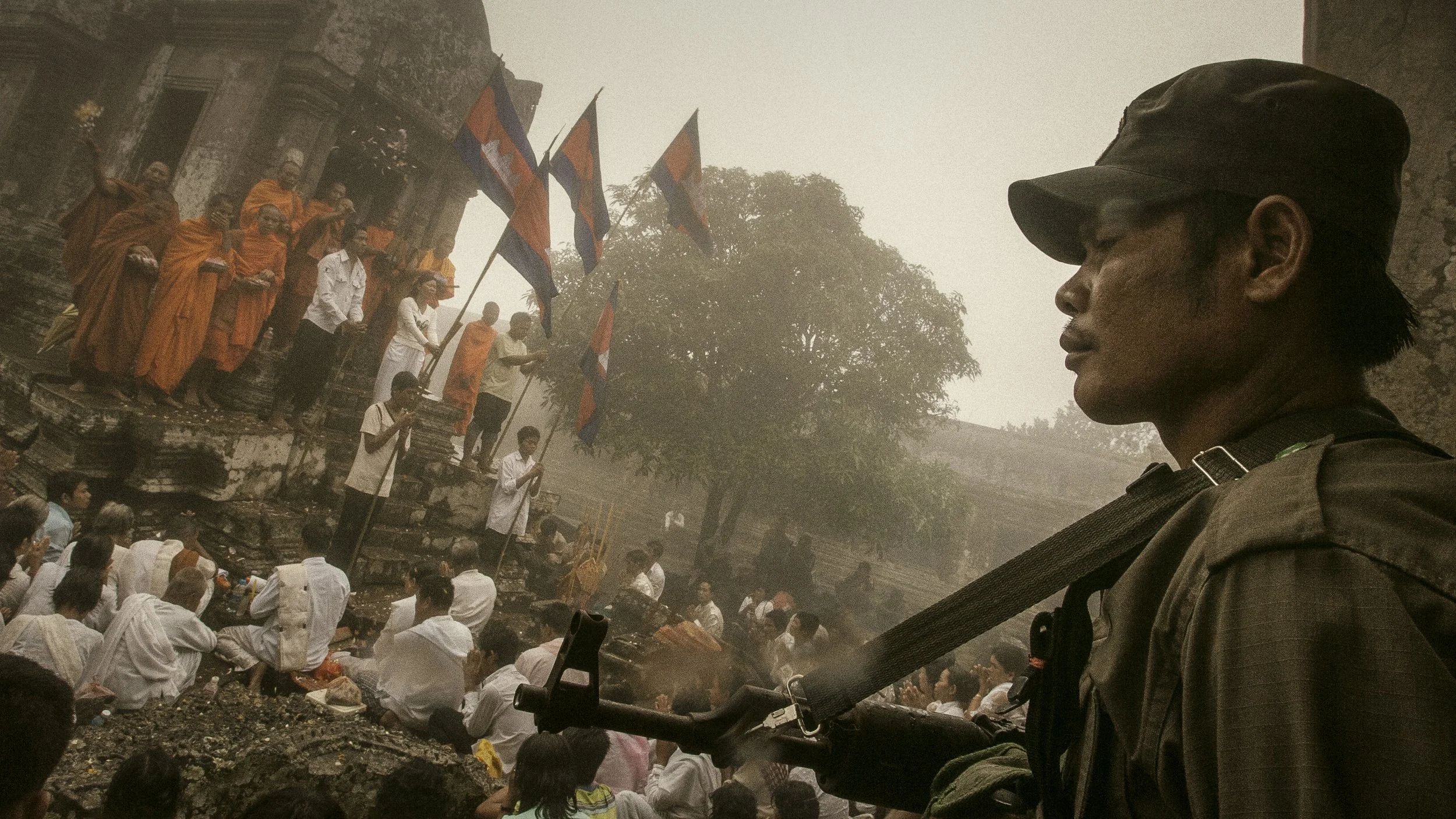 An RCAF soldier stands vigil as mist envelops religious supporters and monks as they join together in prayer occupying one of Preah Vihear Temple’s inner sanctums. 