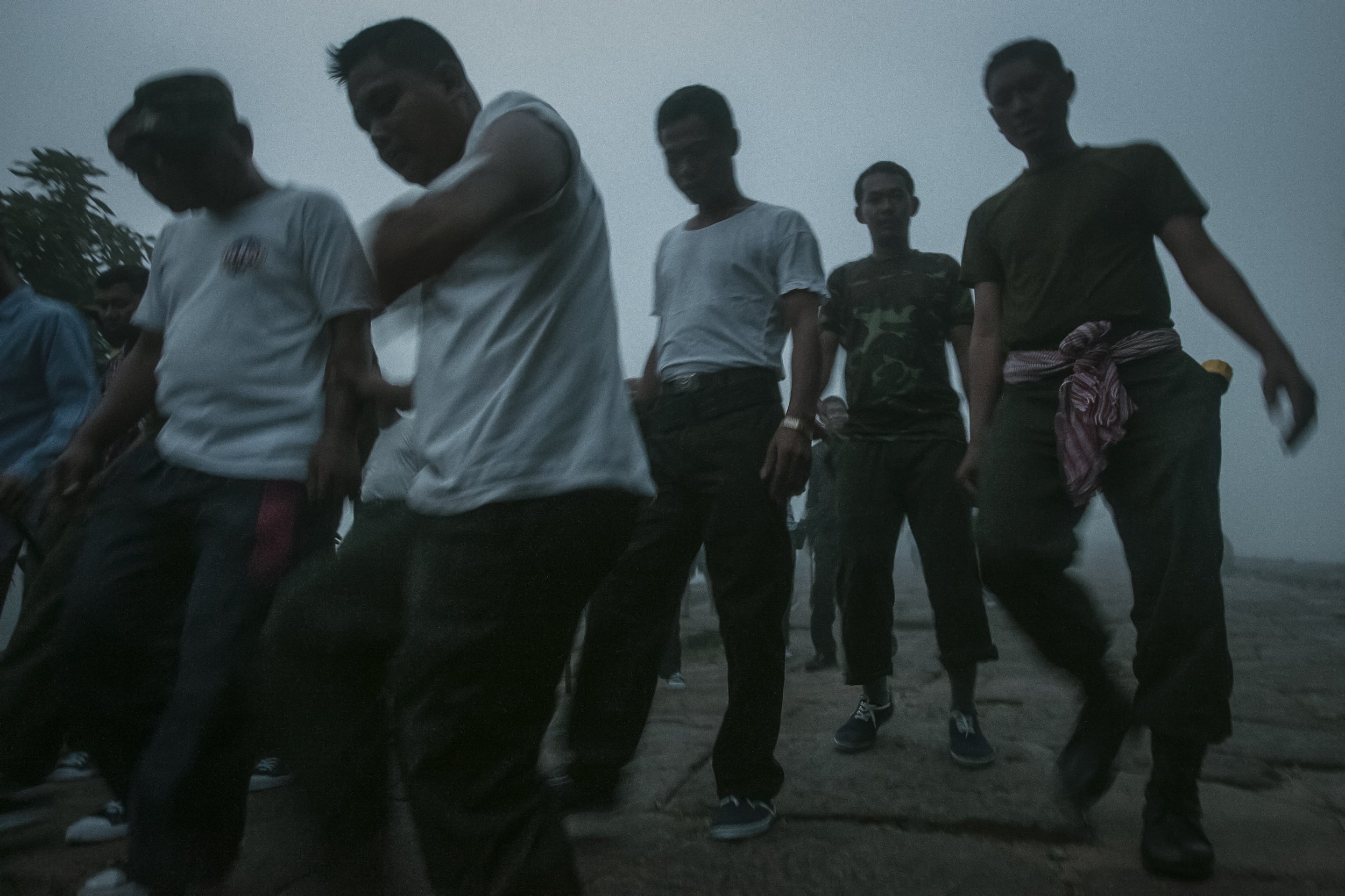 Early morning physical training begins for Cambodian soldiers at the temple steps descending deep into the surrounding jungle.