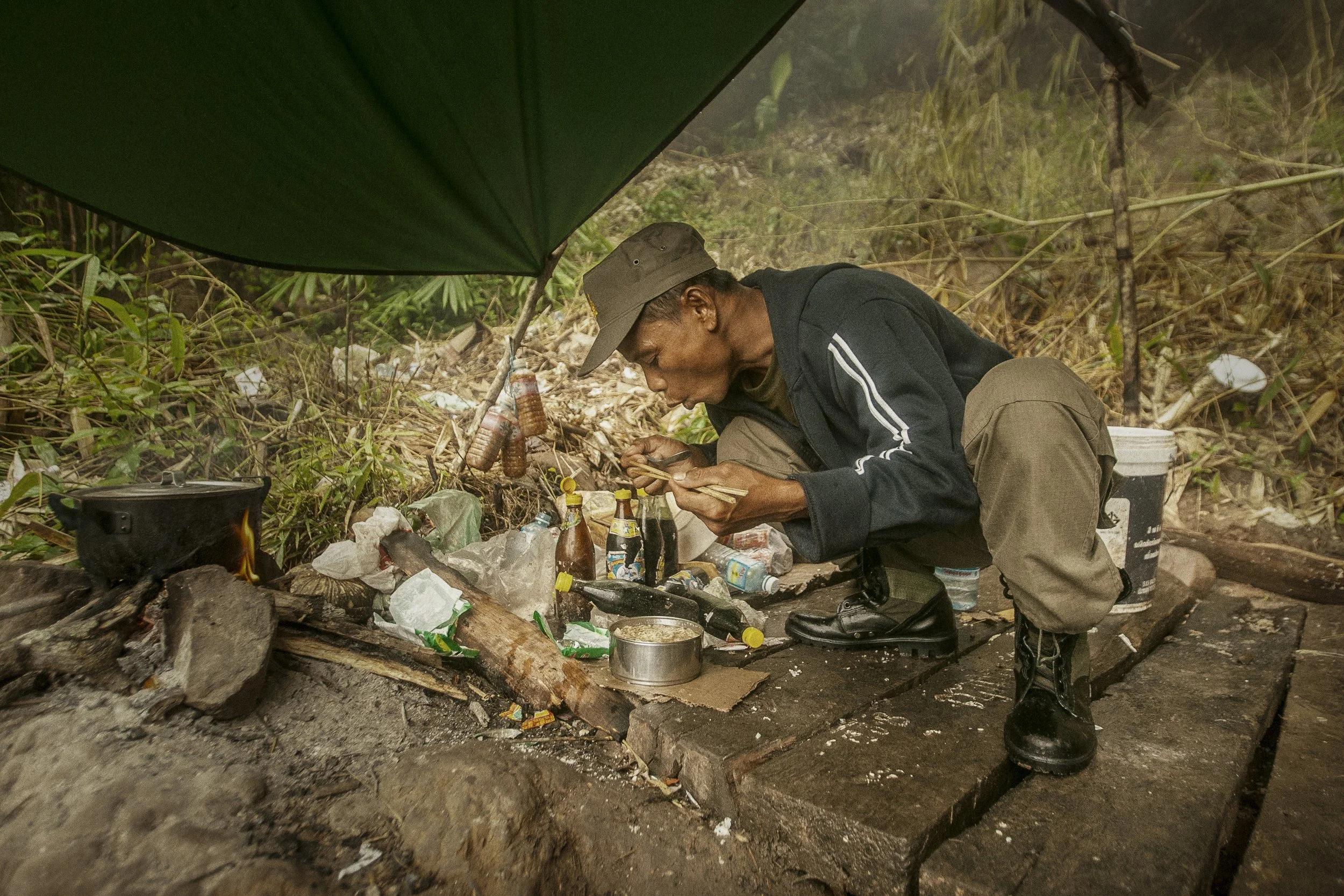 A substantial and elaborate kitchen setup alongside the jungle trail. Food and warm meals seemed to be the priority in what were cold and wet conditions for many posted here.