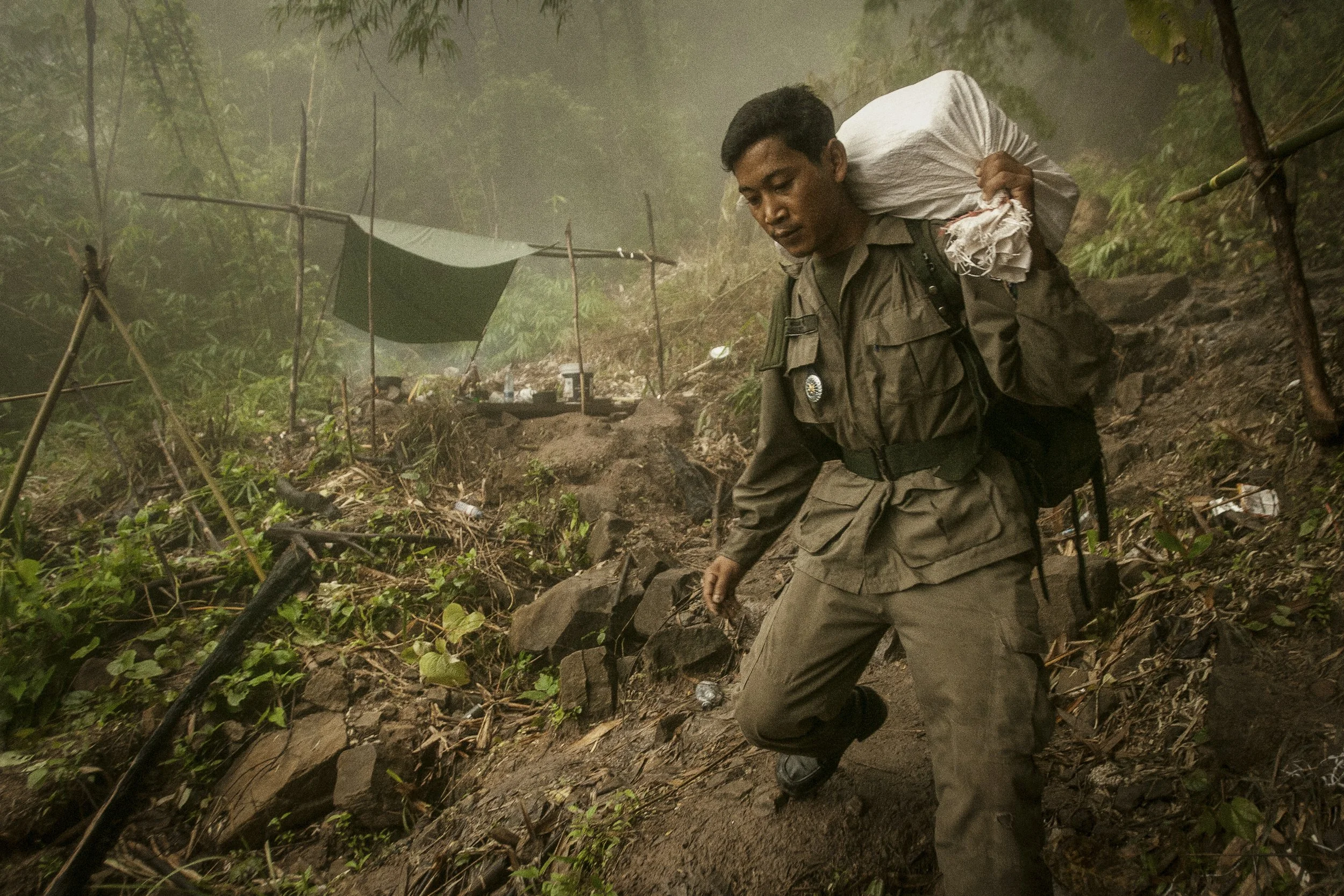 Supplies and provisions are transported by troops down the steep and precarious mountain terrain between outposts.
