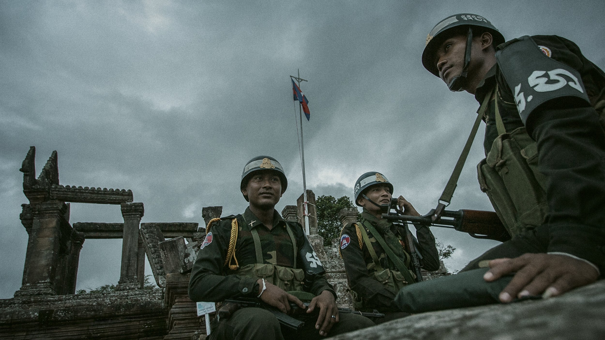 RCAF Military Police guard the flag pole atop the ancient temple’s highest point. They prudently survey the surrounding temple ruins this cloudy evening in Northern Cambodia.