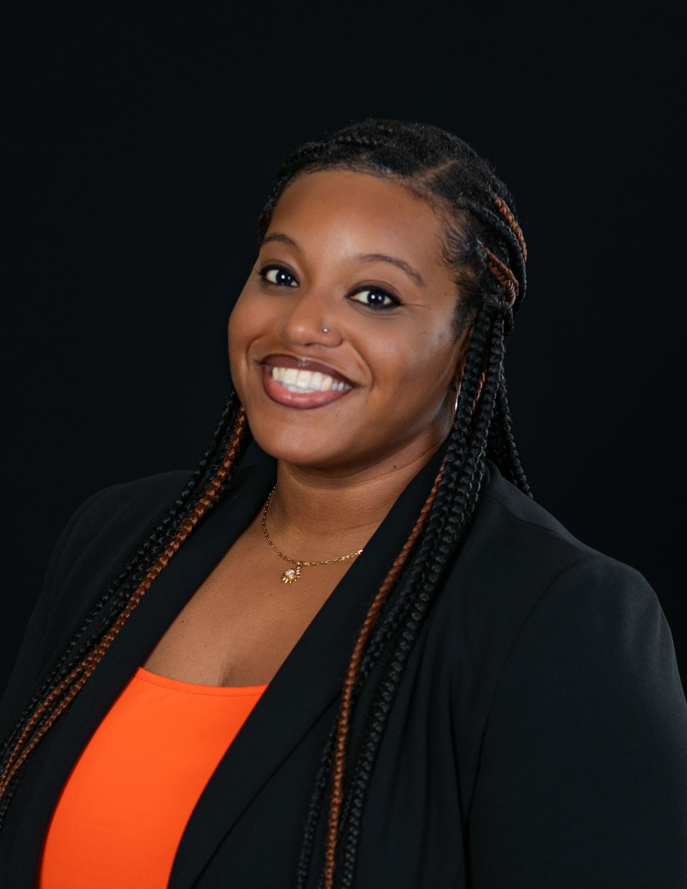 emerging-professionals-network-headshot-black-jacket-orange-top.jpg