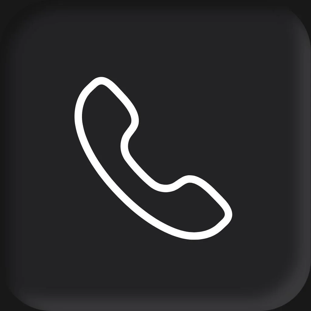 A woman with long brown hair, blue eyes, wearing a striped blue and white shirt and a dark blazer, smiling in a home kitchen setting for a headshot with Cannonfire Photography in Orlando.