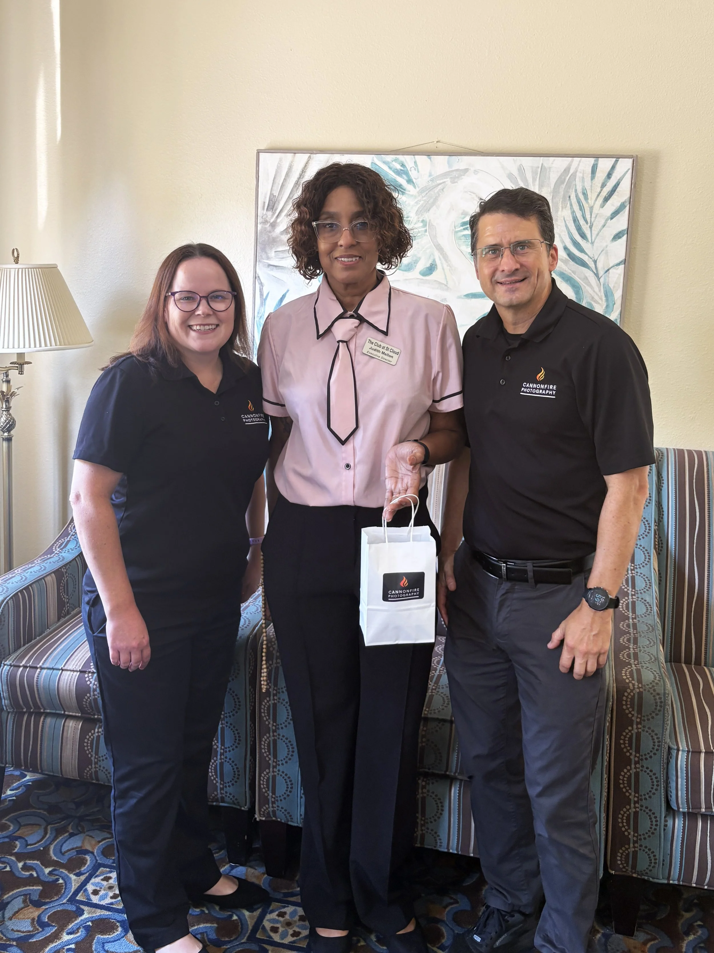 Jason and Kara Cannon presenting an Amazon gift card to headshot raffle winner Judith at her St. Cloud senior living community