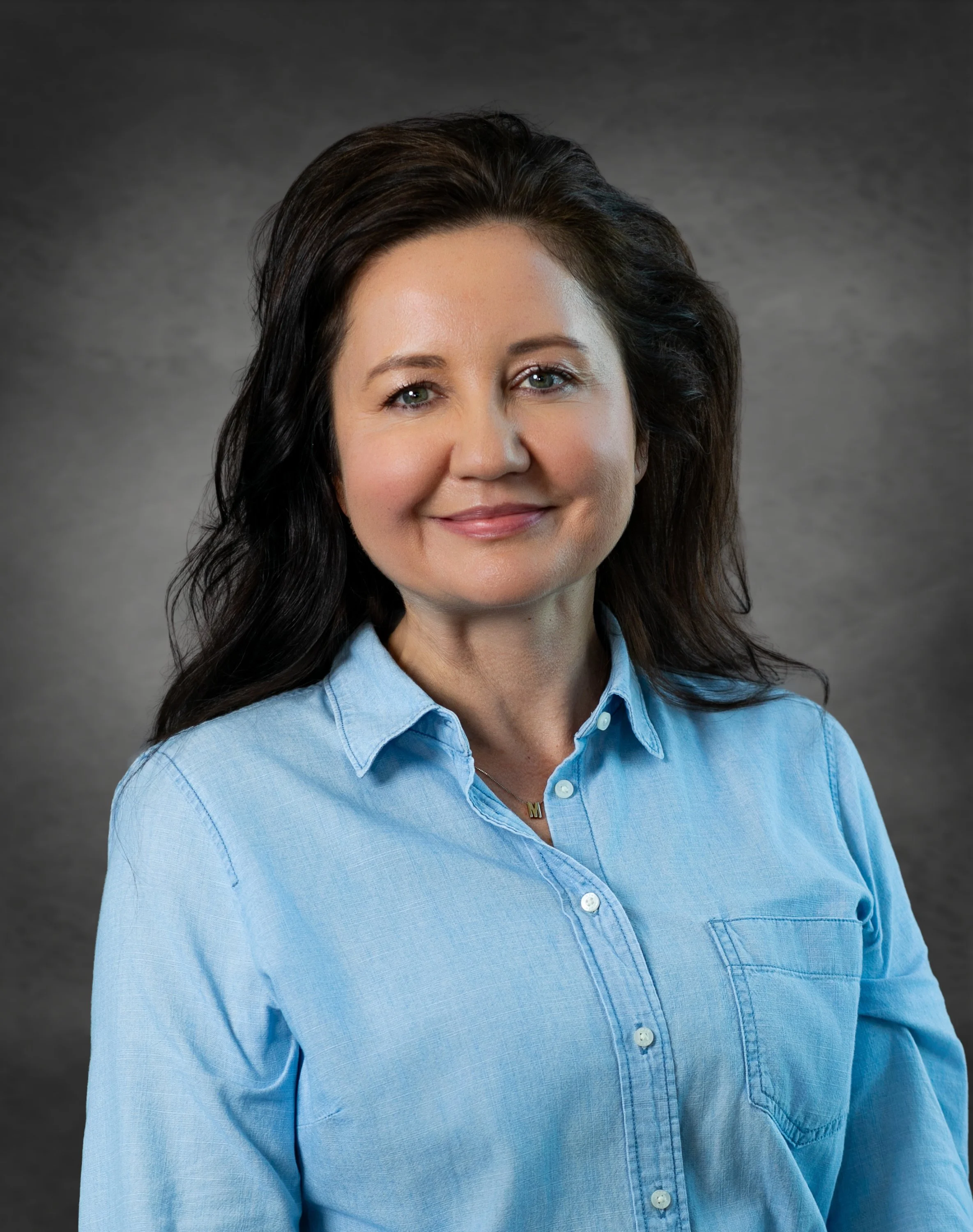 Professional smiling during an on-location headshot session in the Orlando area
