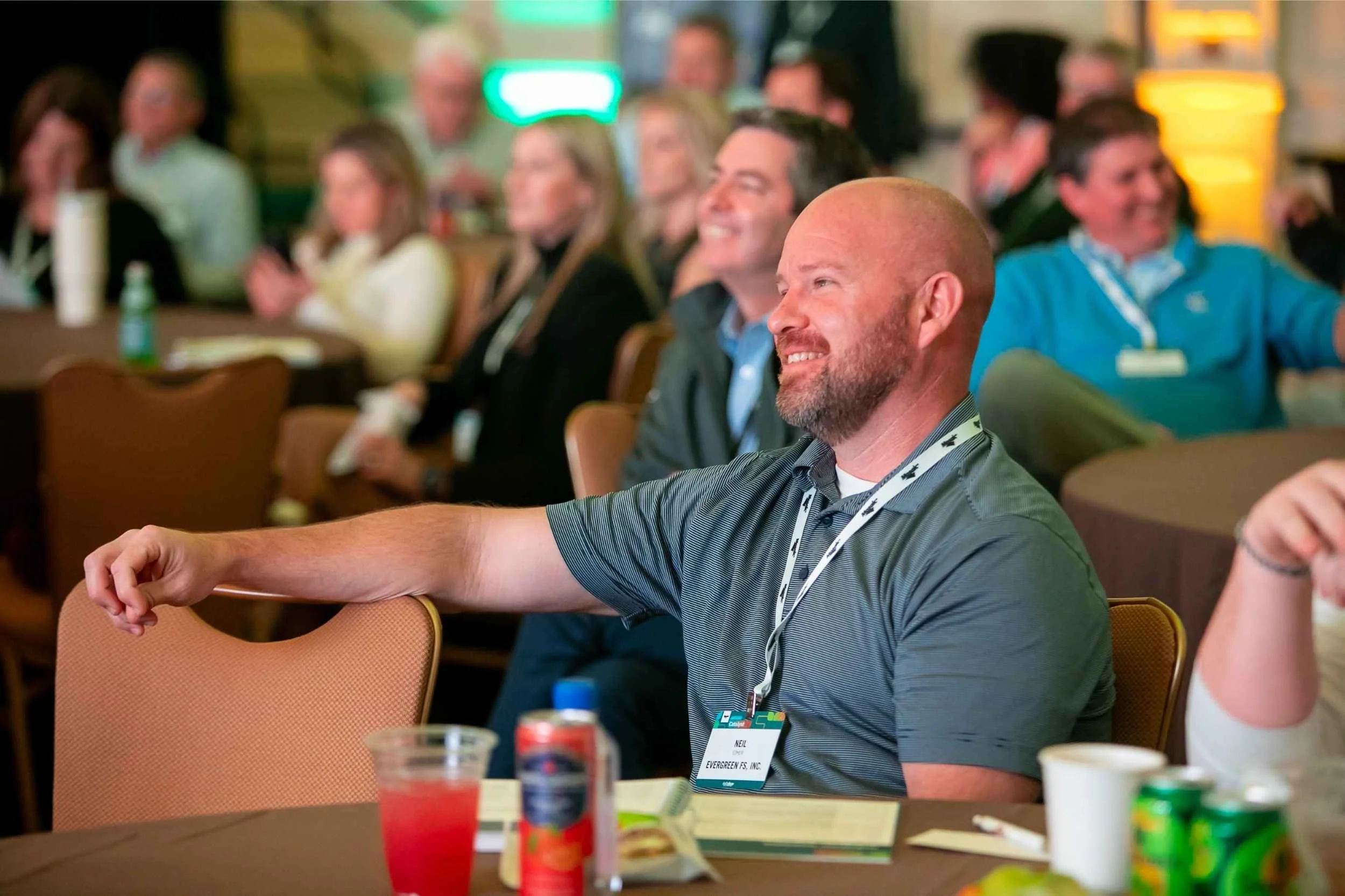 Audience member smiles in response to a speaker presentation at an Orlando conference