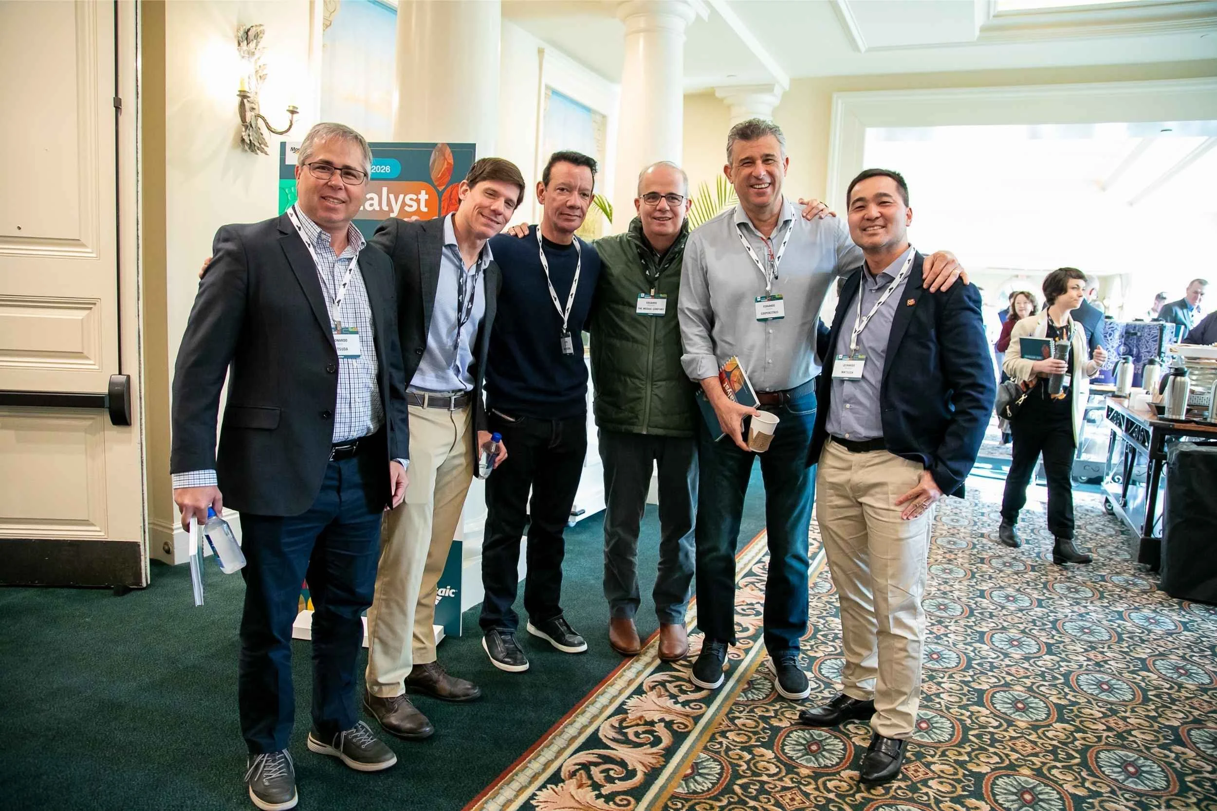 Attendees stand and pose together in a group for a candid moment at an engineering conference in Orlando