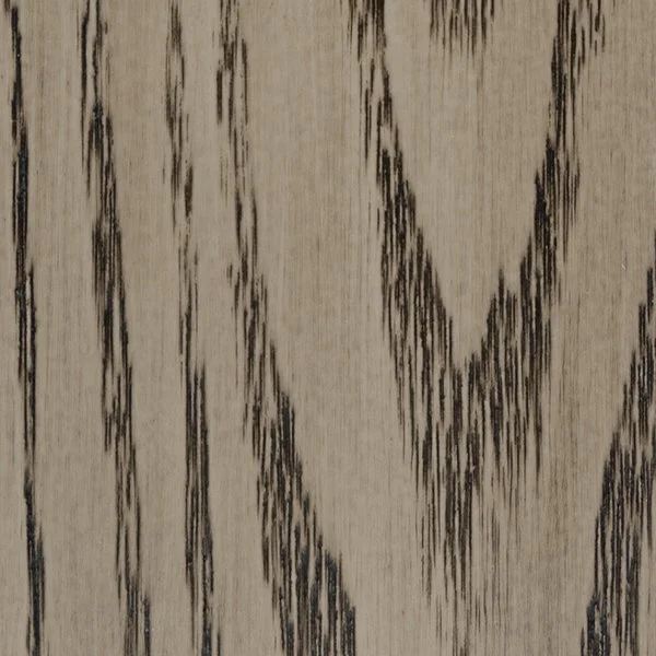 Close-up of a wood surface with a light stain and dark grain patterns.