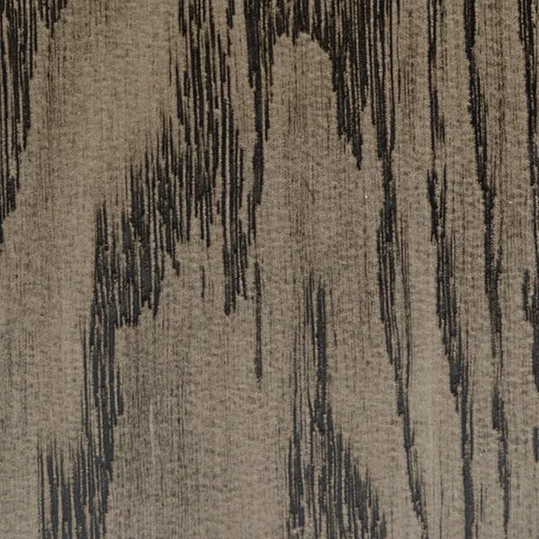 Close-up of a wooden surface with a weathered finish, showing vertical dark streaks and grain patterns.